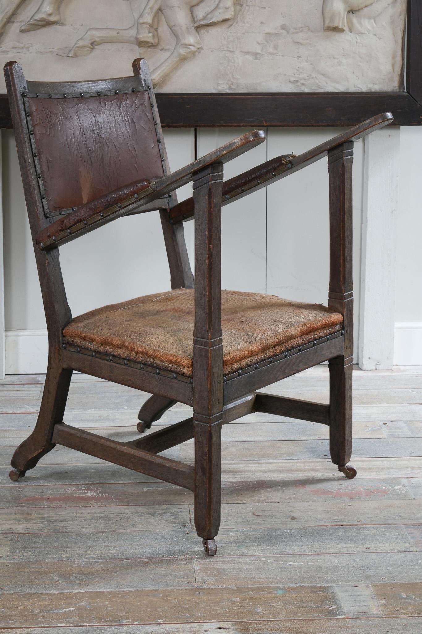 A rare example produced in the English Gothic taste.

Dry oak frame with remnants of the original leather upholstery.