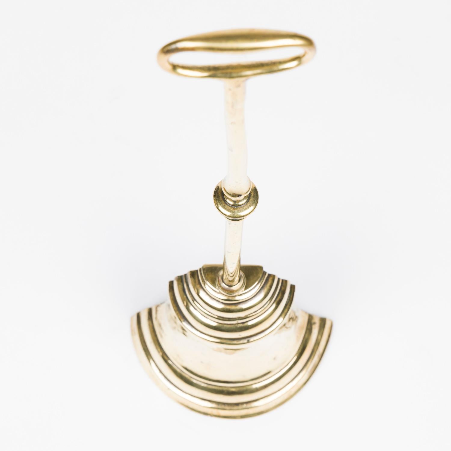 A mid 19th century brass bell shaped door porter.

With weight base.

Weight: 6.2 lbs.