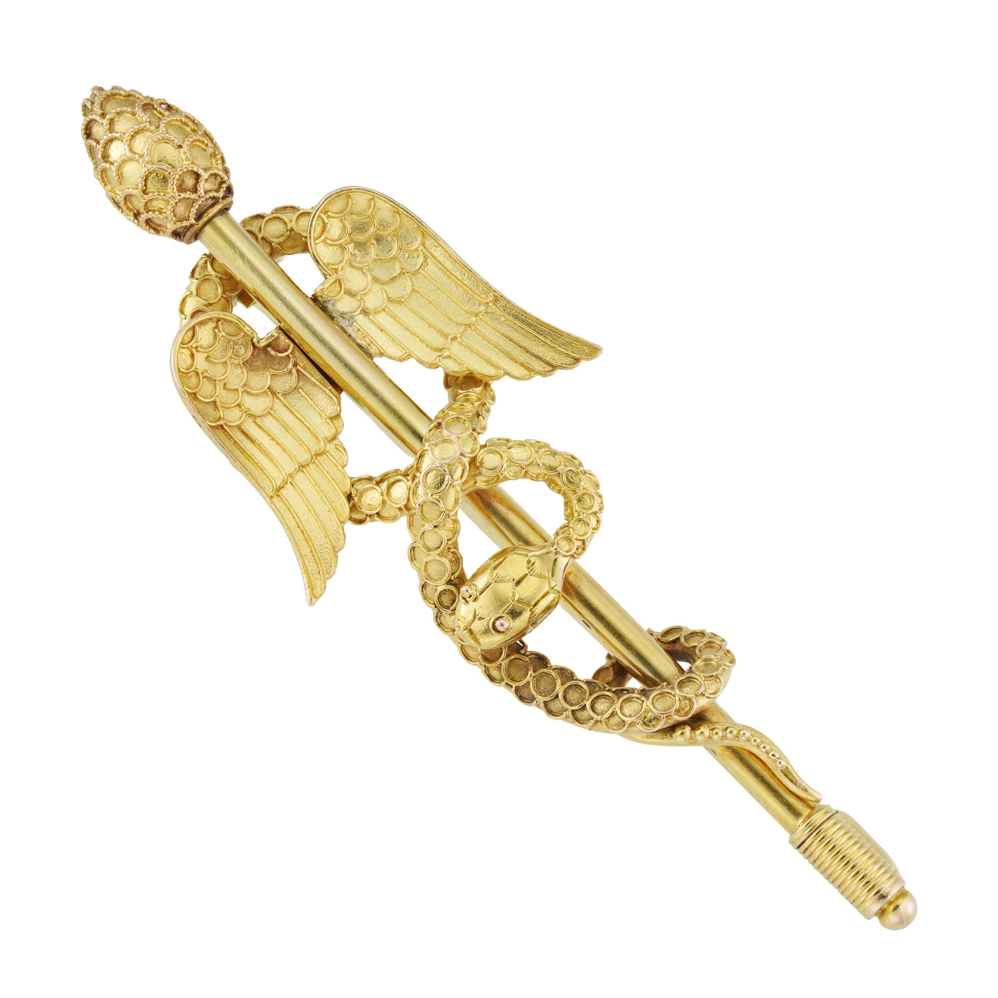 A mid 19th century Caduceus brooch, in the archaeological revival style with gold wirework and gold beading decoration, circa 1850, measuring 6x2cm, gross weight 7.9 grams.

This antique brooch is in very good condition for its age. Unmarked, tested