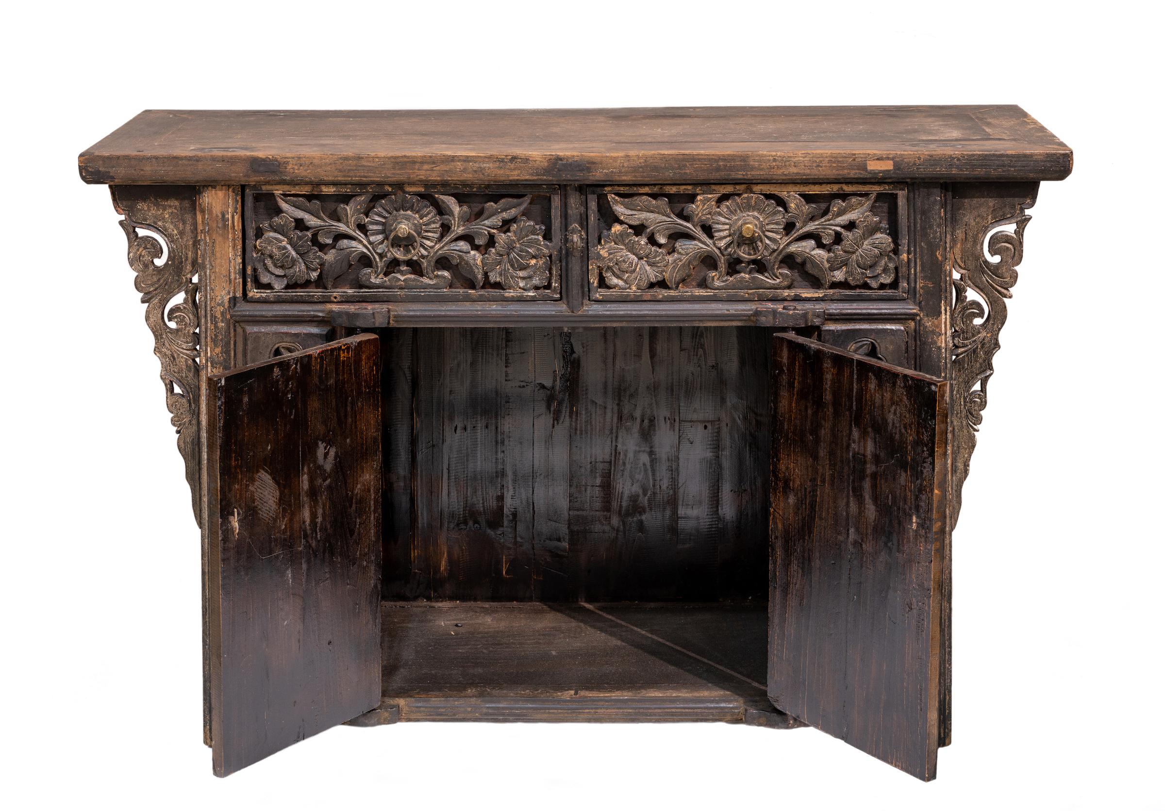 A mid-19th century coffer-style cabinet from Shanxi province, China. Approx. 150-200 years old. The carvings on this cabinet has a floral theme, and the carvings on the drawers are outstanding as they are very deep and 3D. In contrast the doors have