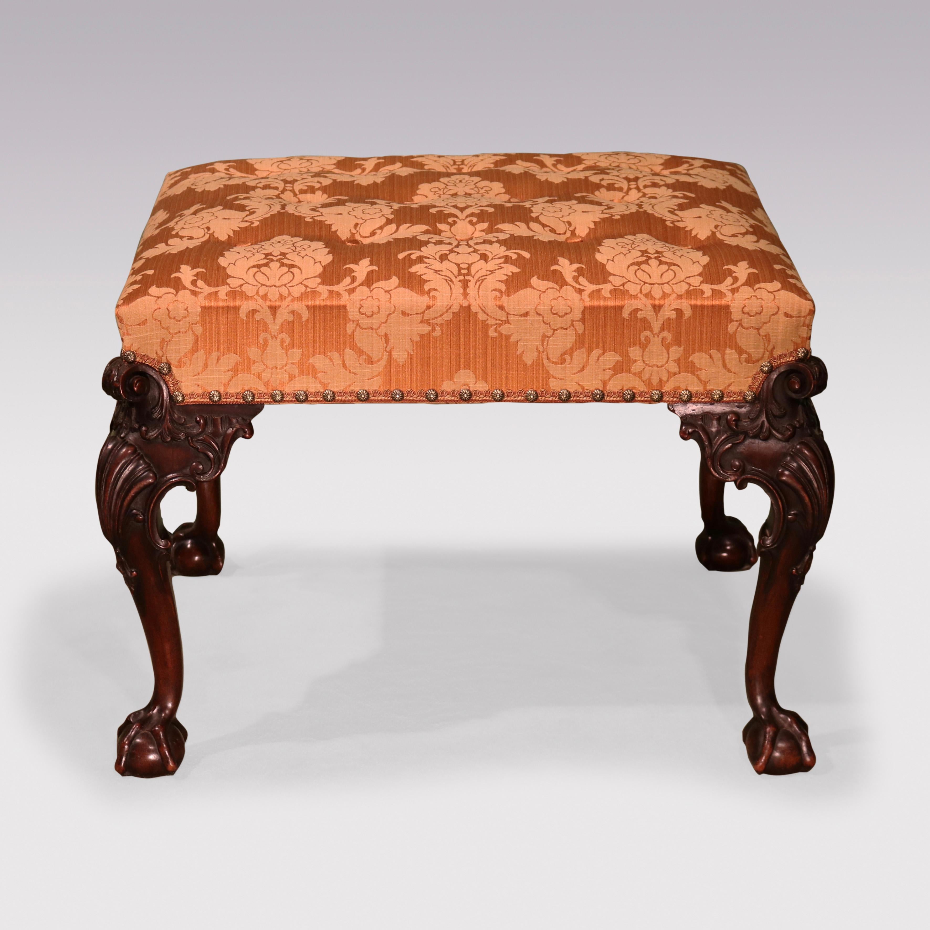 A mid-19th Century Chippendale Revival mahogany Stool, having upholstered & buttoned rectangular top supported on acanthus & scroll cabriole legs with shell carving to the knees, supported on claw & ball feet.