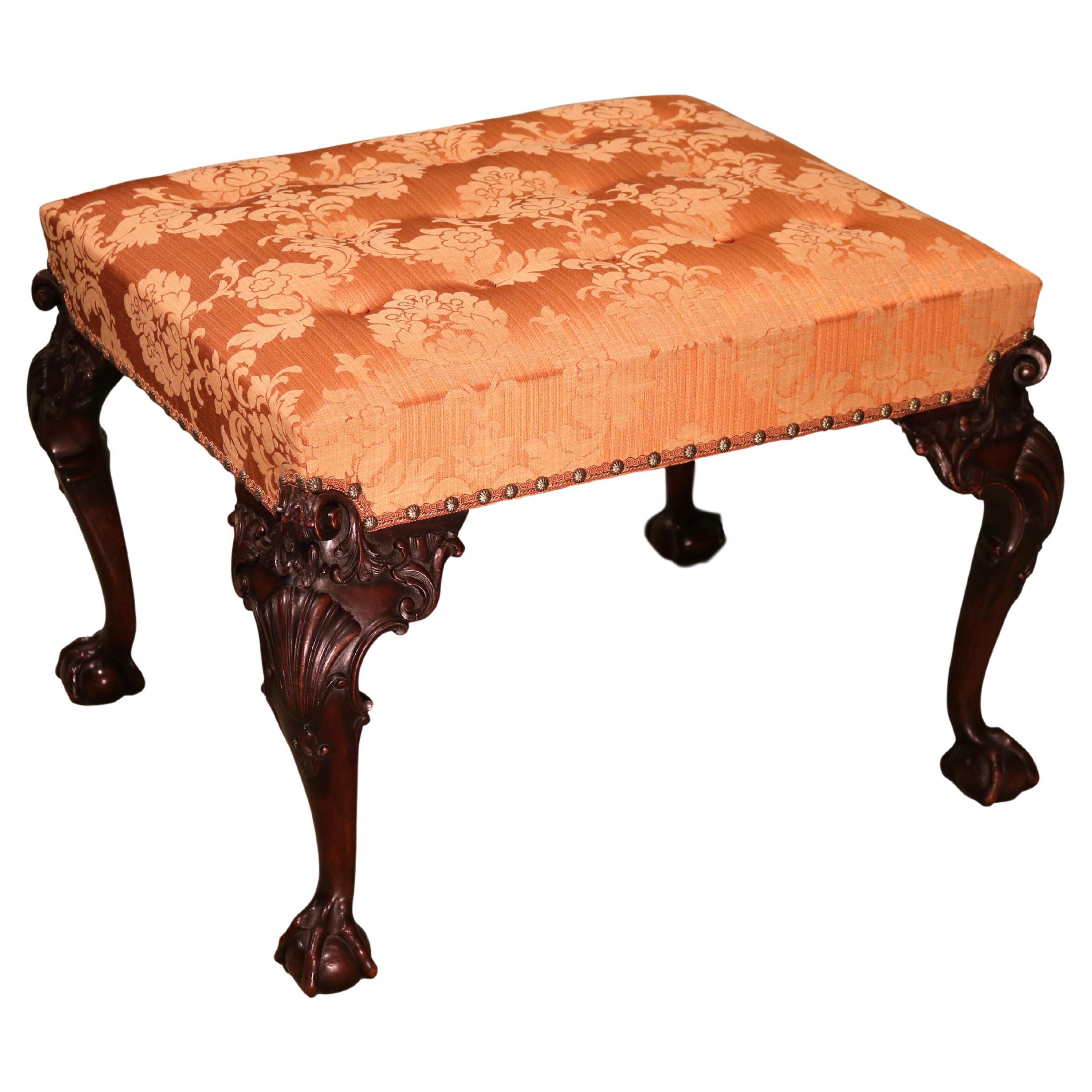 A mid 19th century carved mahogany stool in the Chippendale style