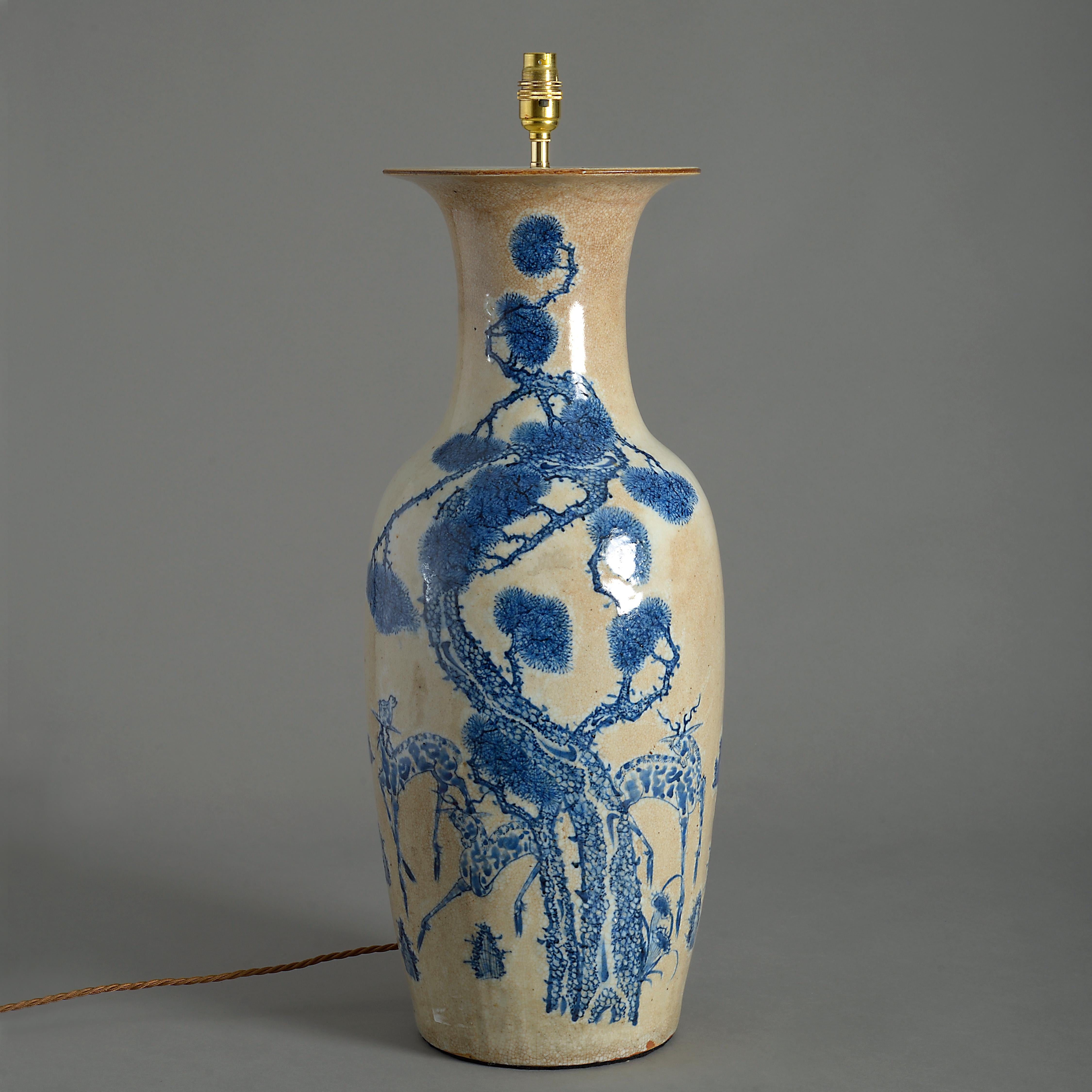 A tall mid-19th century crackle glazed porcelain baluster vase, with blue and café au lait decoration.

Late Qing dynasty

Dimensions refer to vase excluding shade and electrical components.