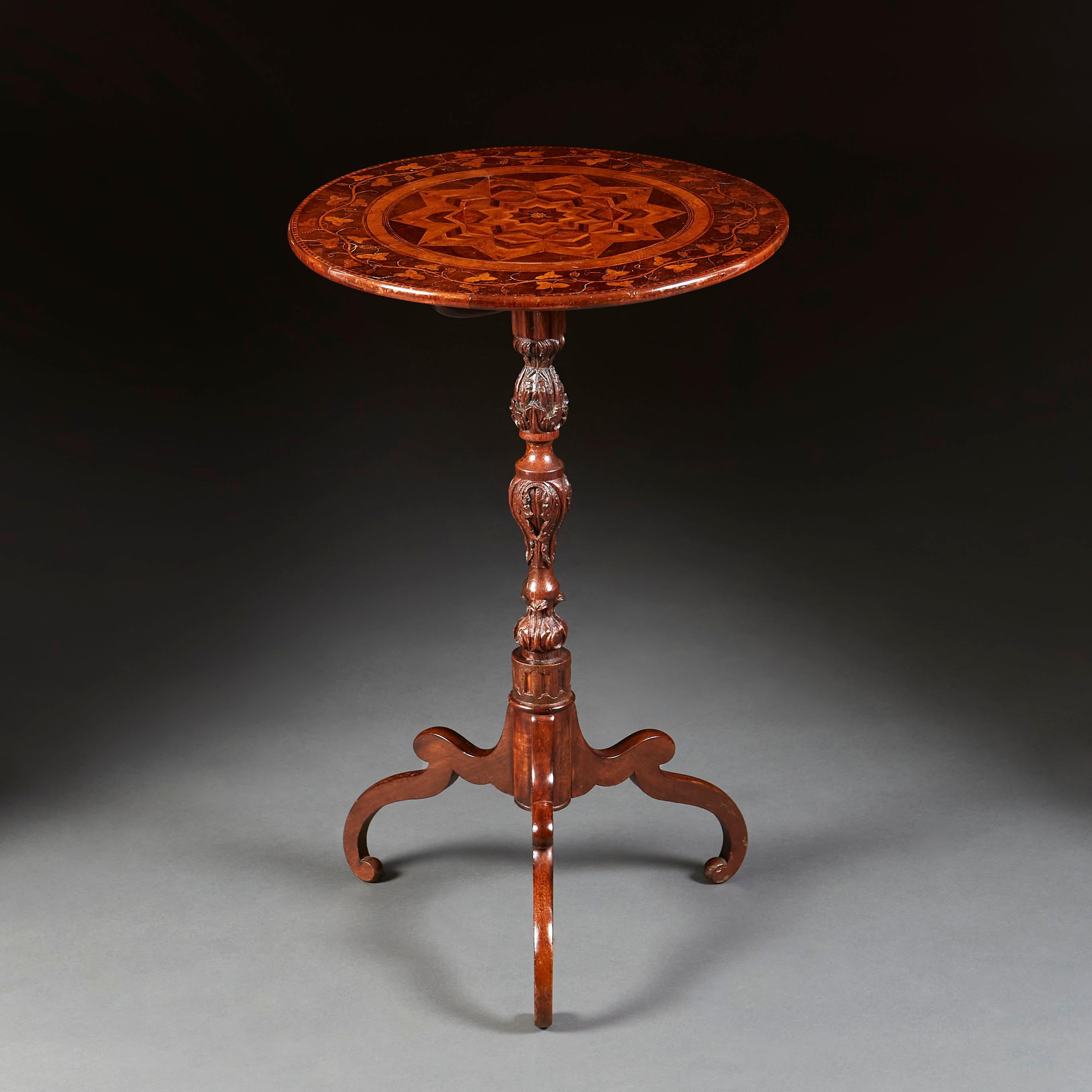An unusual mid nineteenth century walnut occasional table, the top inlaid with a band of vine leaves and grapes, with central medallion of radiating star, all supported on a turned pedestal, with stylised tripod base.
