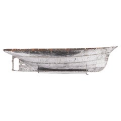 A mid 19th century riveted steel plate hull of a model steam yacht.