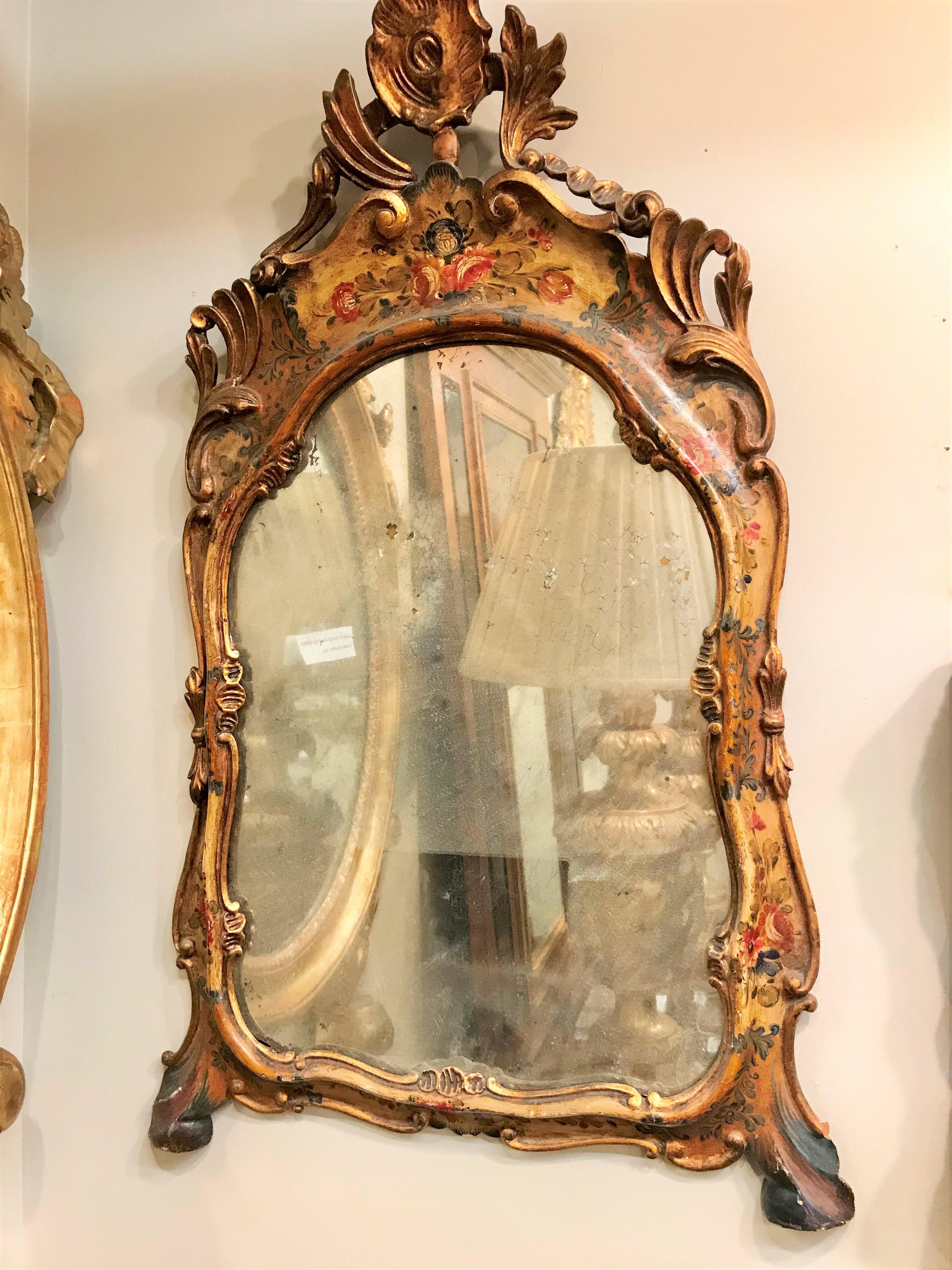 A floral and parcel gilt decorated Venetian mirror . The probable mercury plate in charming disintegration and decay . The paint with dirt and grime