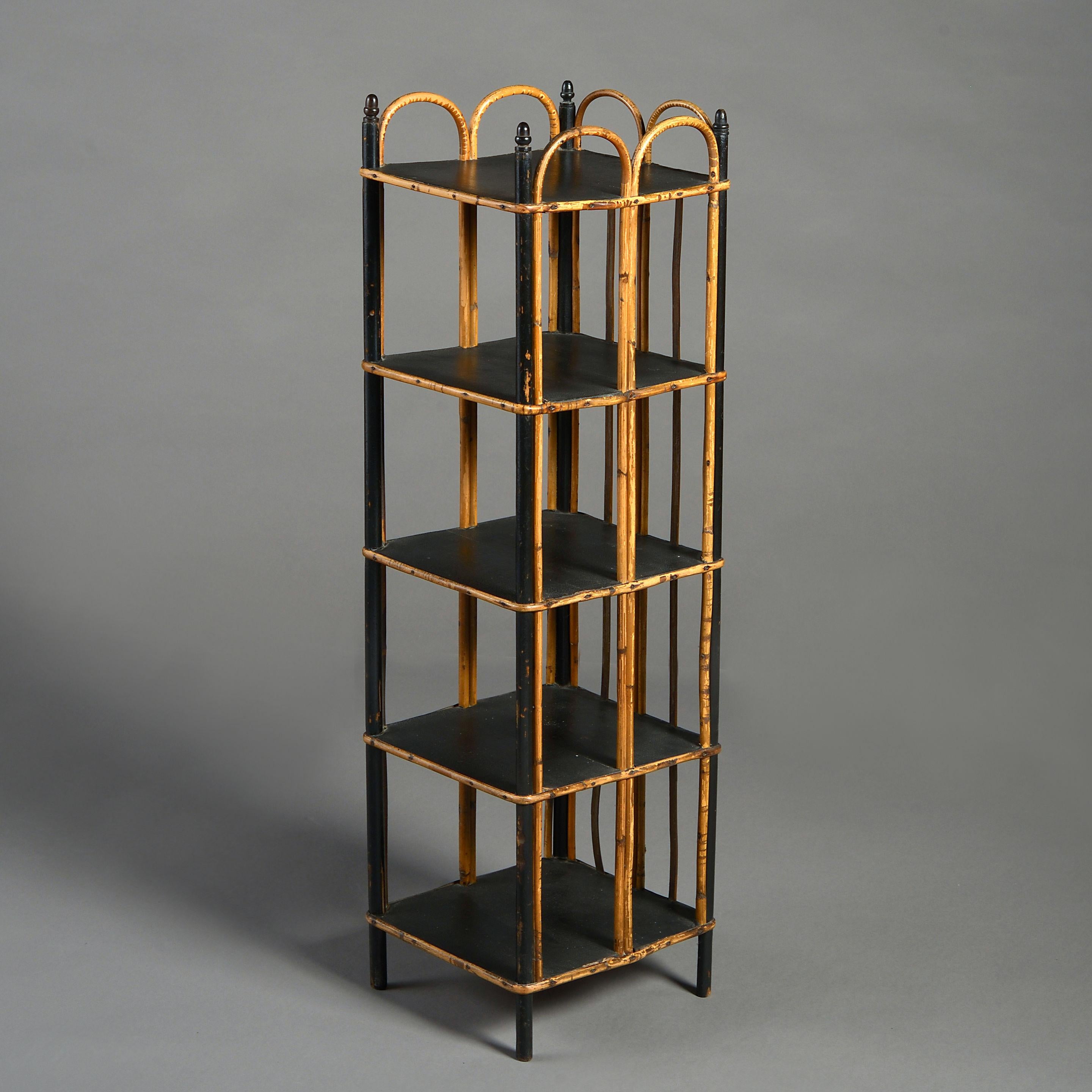 A mid-19th century Victorian period five tier shoe rack, the ebonised shelves with hooped bamboo supports.