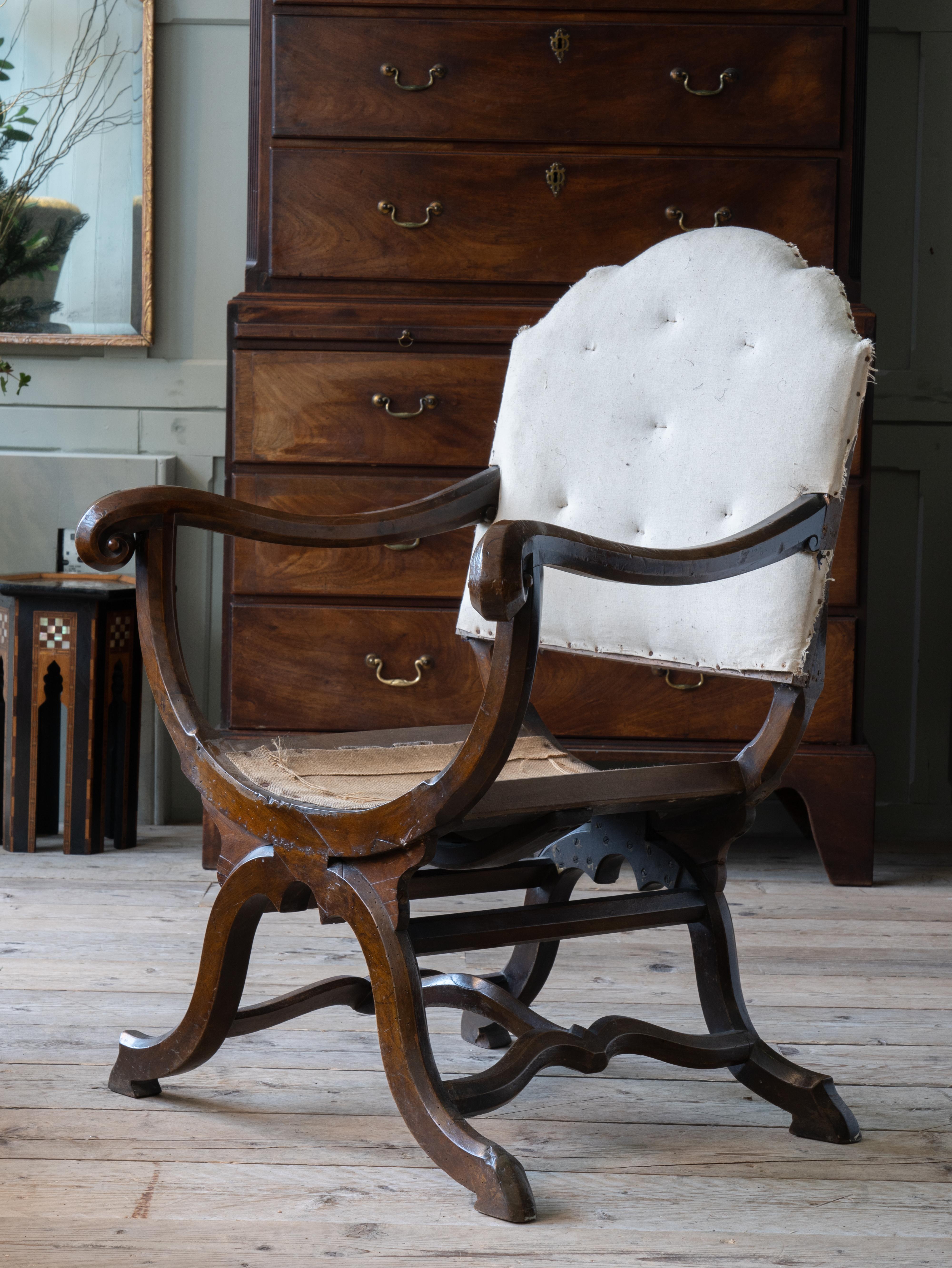 A mid 19th century oak X frame armchair.

Sculptural form, original surface.