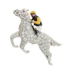 A mid 20th Century diamond and enamel jockey brooch