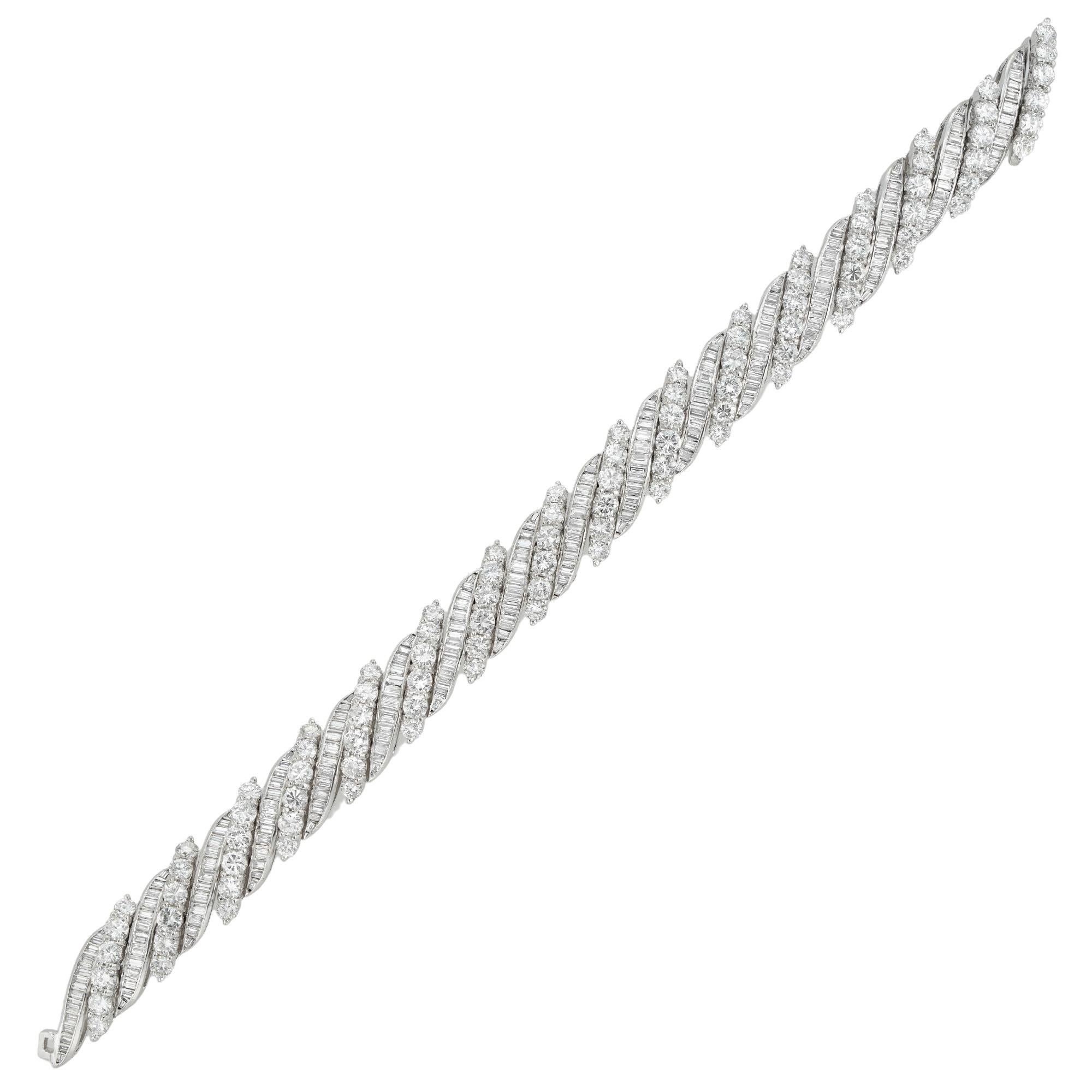 A mid-20th century diamond-set bracelet, sixteen links set with small round brilliant-cut diamonds graduating from the centre and alternating with sixteen baguette-cut diamond-set links, the diamonds estimated to weigh 12¾ carats in total and