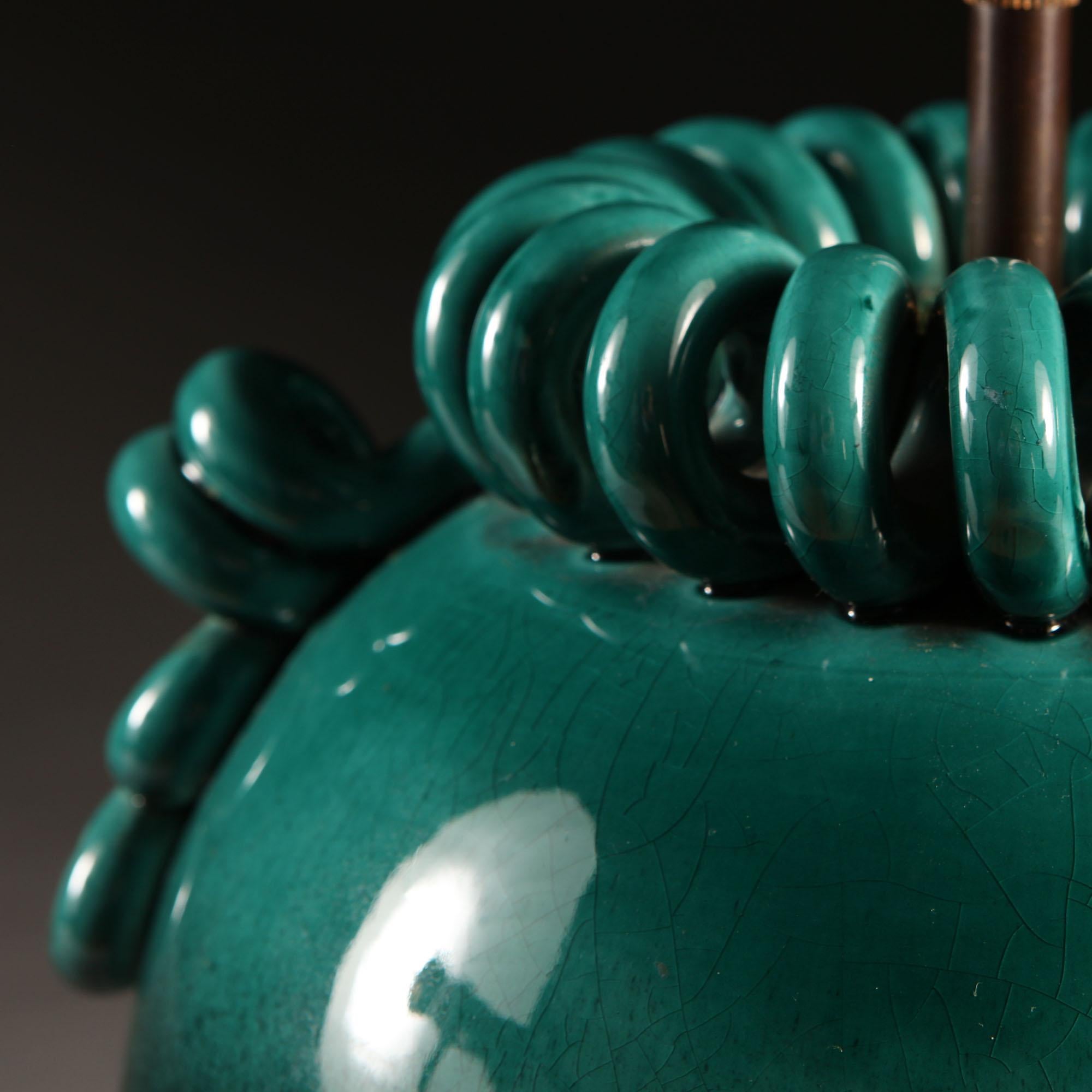 A mid-20th century Italian art pottery vase with turquoise glaze fading into dark green, with serpentine decorative mounts to the rim and serpentine handles to each side, now mounted as a lamp.

Please note: lampshade not included.

Currently