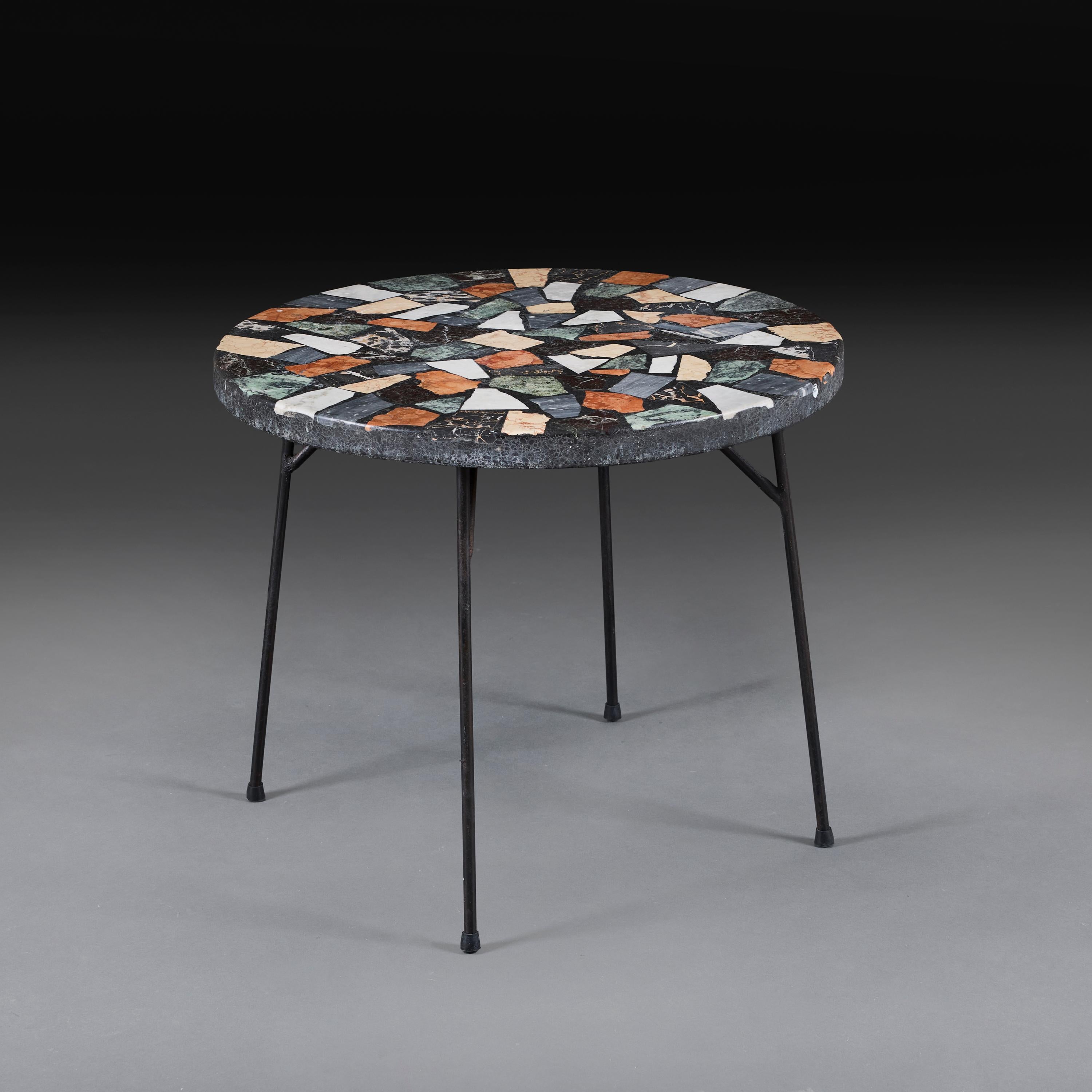 Italy, circa 1960

A mid-twentieth century terrazzo marble table, the top featuring fragments of Sienna, Portoro, Carrera and Red Verona Marbles, all supported on black metal legs.

Height 55.00cm

Diameter 66.00cm