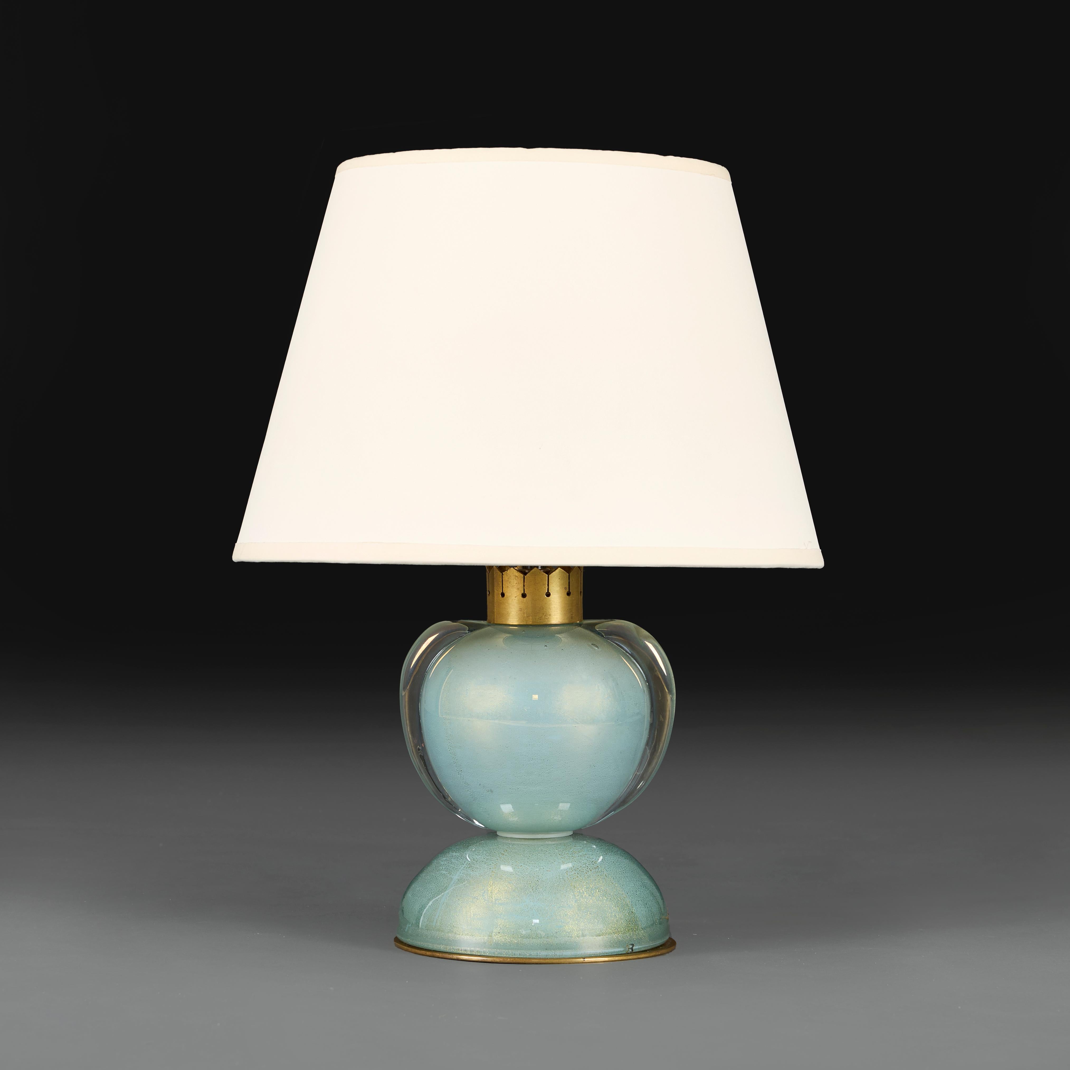 Italy, circa 1950
An unusual early twentieth century Murano glass aquamarine lamp of diablo form, with handles to each side and with gold flecks throughout.

Height of lamp         19.00cm
Height with shade   40.00cm
Diameter                    