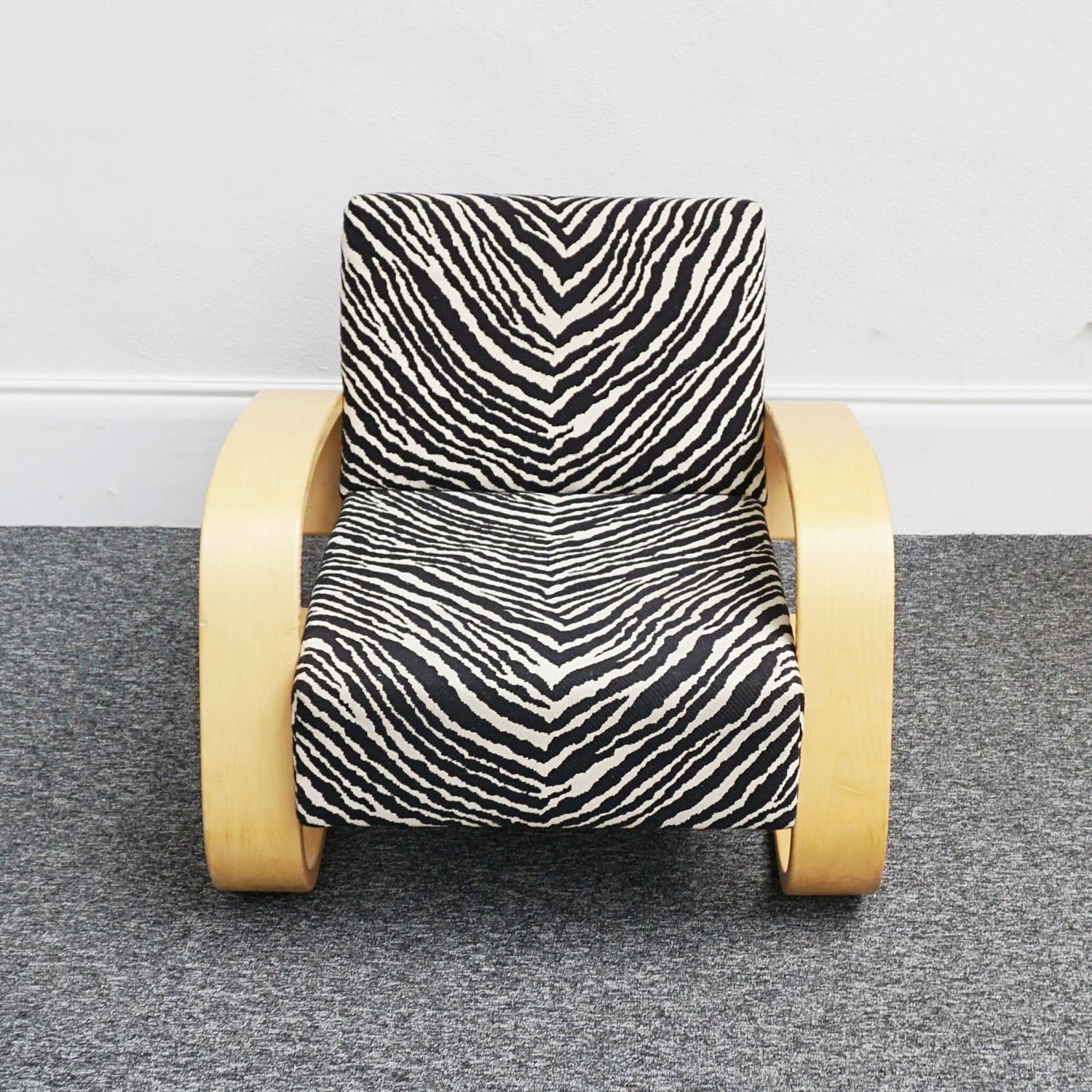 A mid-century tank chair Model 400 designed by Alvar Aalto and produced by Artek. Curved frame with original Zebra' upholstery. 

Dimensions: H 66cm, W 76.5cm, D 81cm.

Alvar Aalto was born in Finland in 1898. One of the founders of the