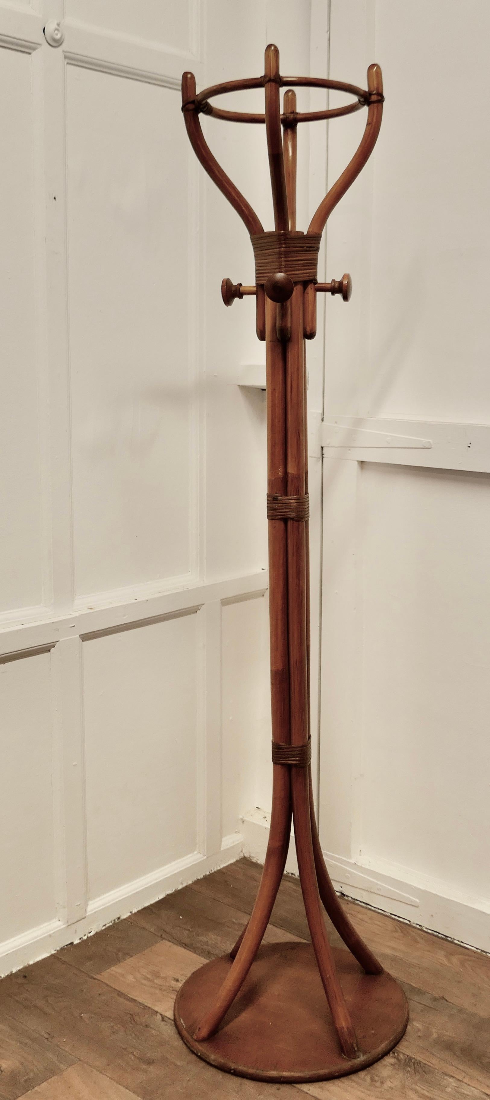 A Mid Century Bent Wood Hall Stand

This is an Unusual Large Hat & Coat Hall Stand, it has 4 upward curving legs which form hat pegs at the top and there are also 4 round coat pegs, all set on a sturdy round base
The Hall Stand is in Good Condition