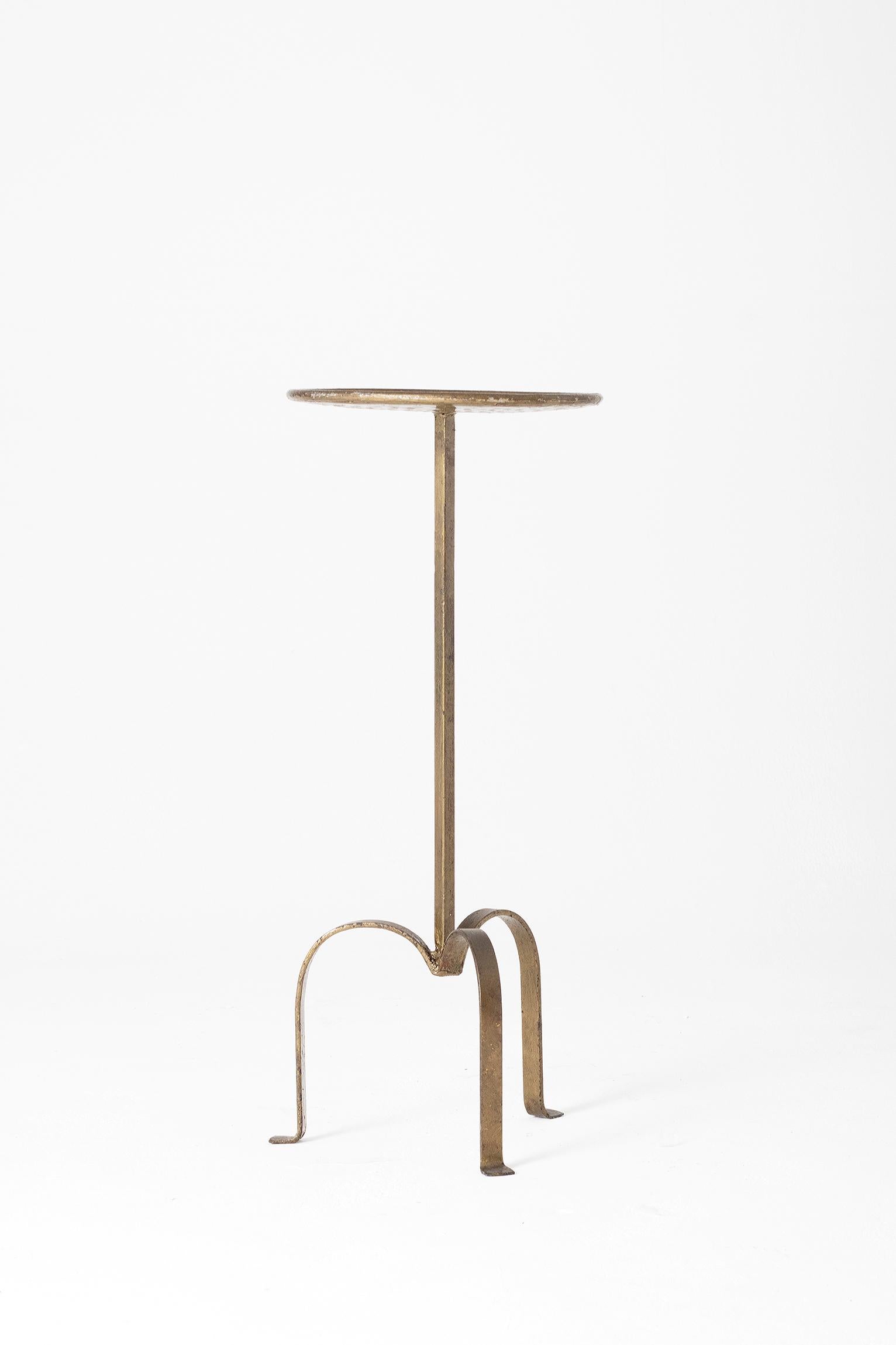 A gold patinated wrought iron martini table
Spain, second half of the 20th century.