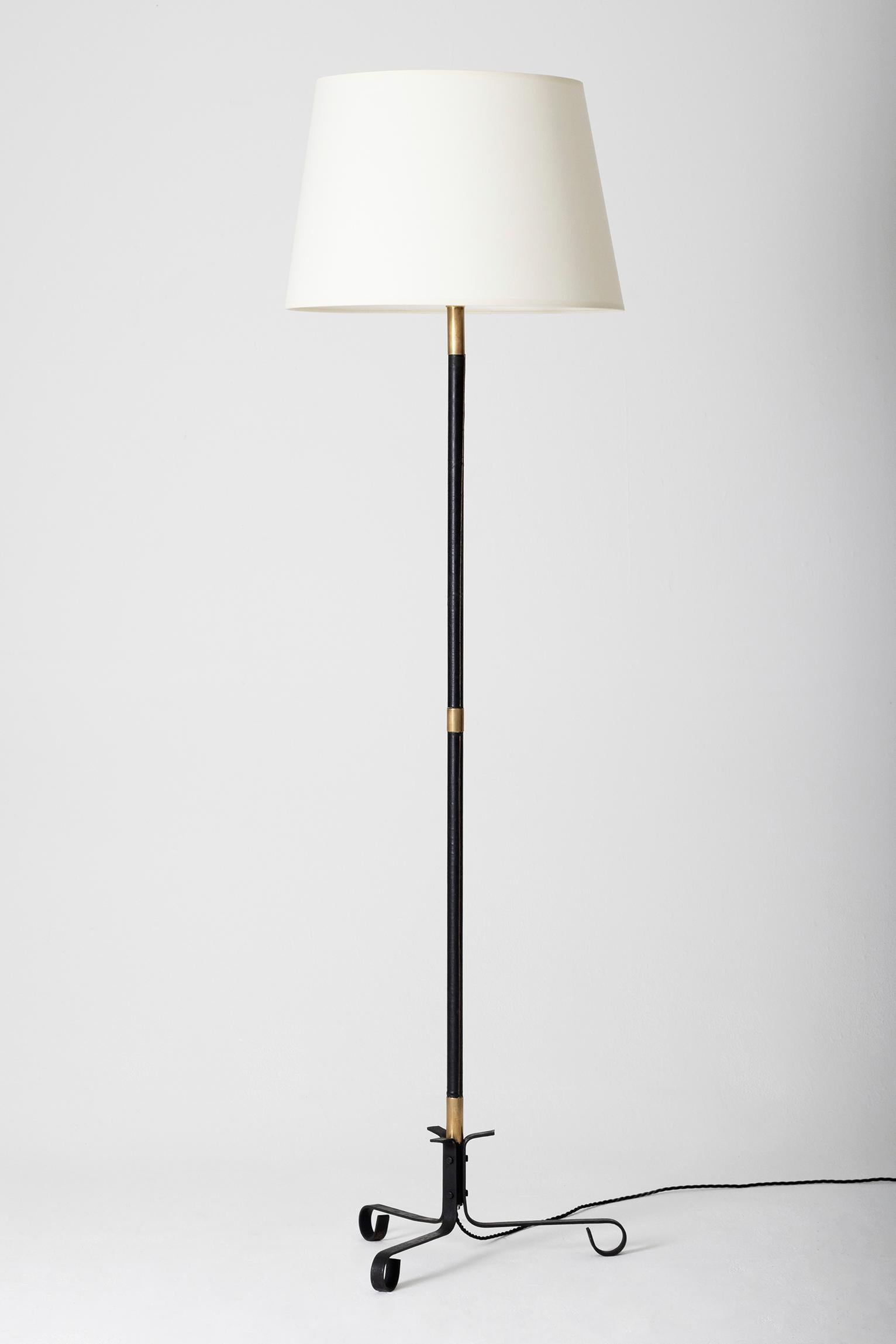 A brass, black leather and black enamelled iron floor lamp
France, circa 1950
With the shade: 164 cm tall by 46 cm diameter
Lamp base only: 138 cm tall by 42 cm diameter.