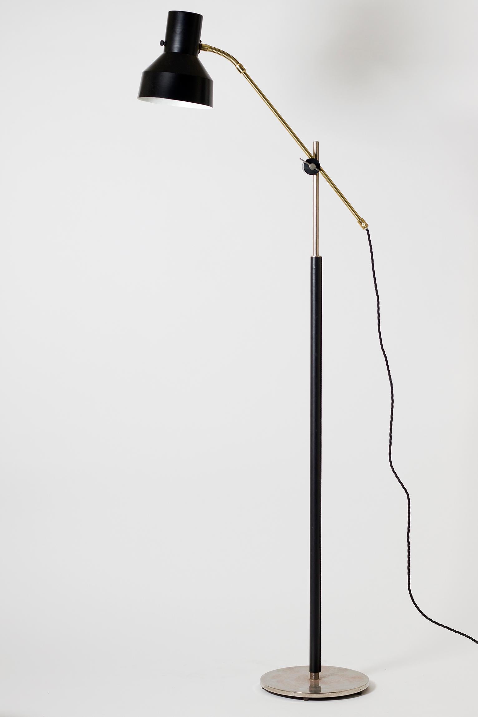 A brass, chrome and black faux leather reading floor lamp
Sweden, circa 1970.
