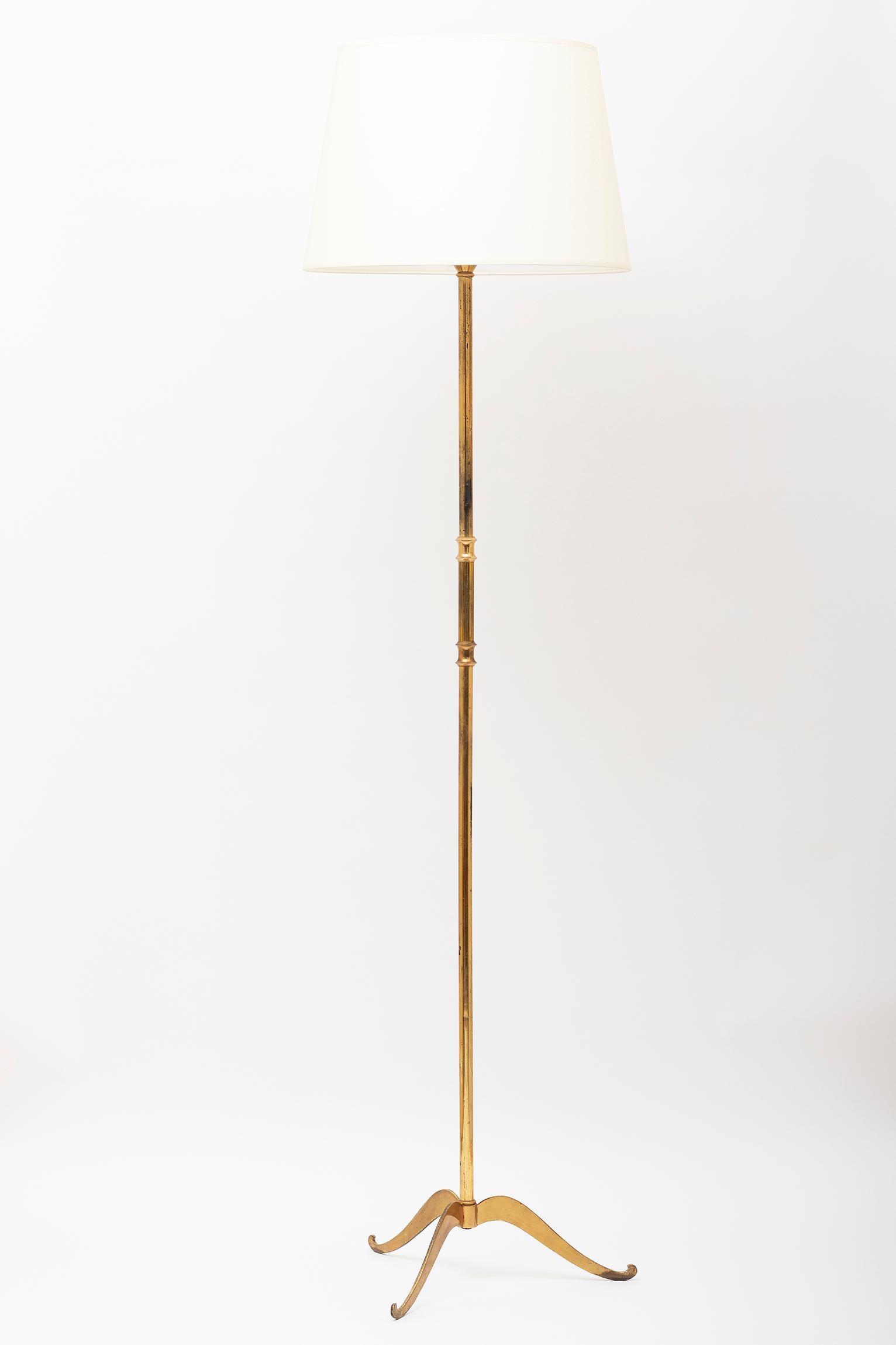 A brass floor lamp, the part reeded stem supported on a shaped tripod base
France, circa 1950
With the shade: 175 cm high by 46 cm diameter
Lamp only: 145 cm high.