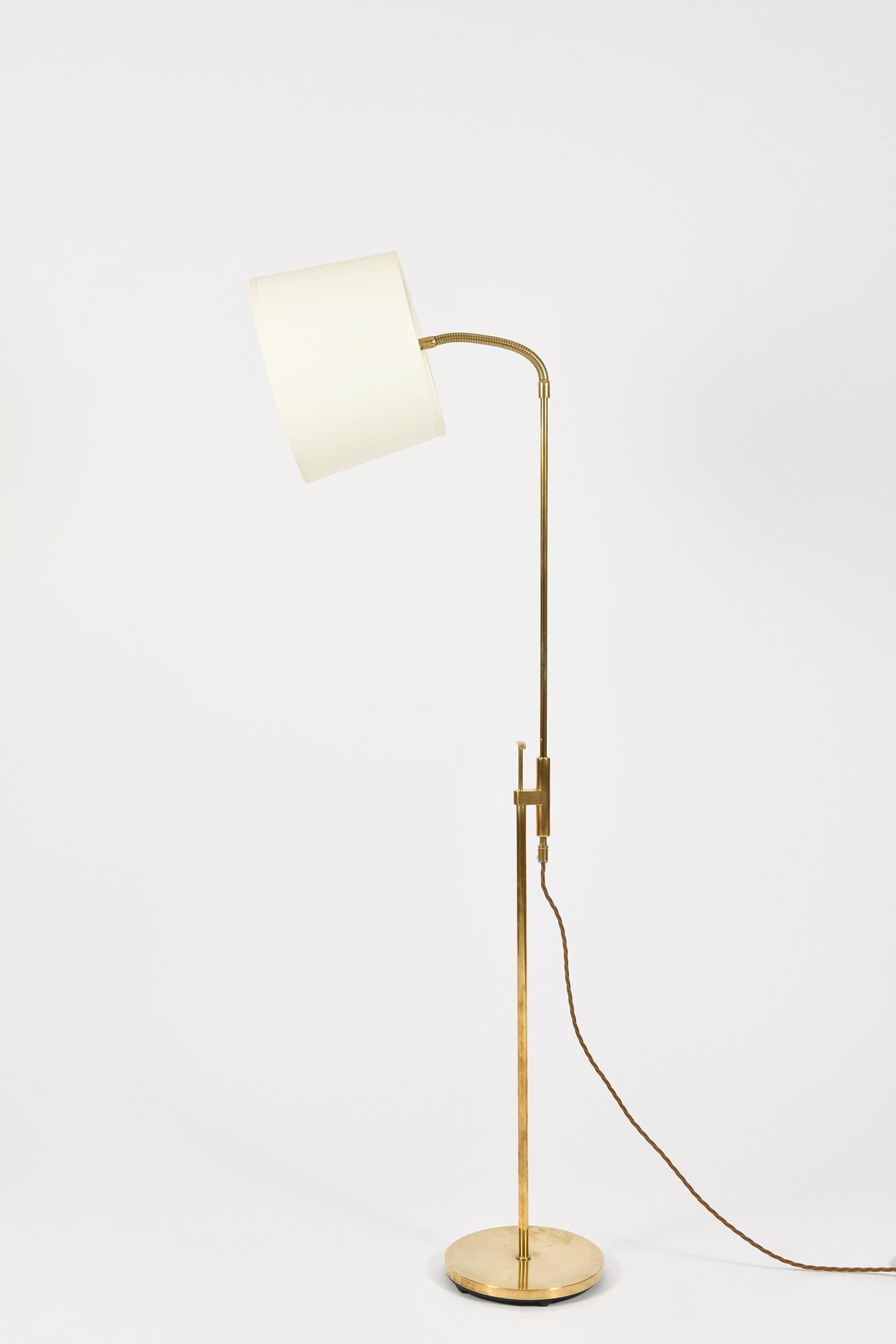A brass telescopic reading floor lamp by Falkenberg Belysning
the stem, of adjustable height and on a circular base, supporting a gooseneck light.
Sweden, circa 1970.
