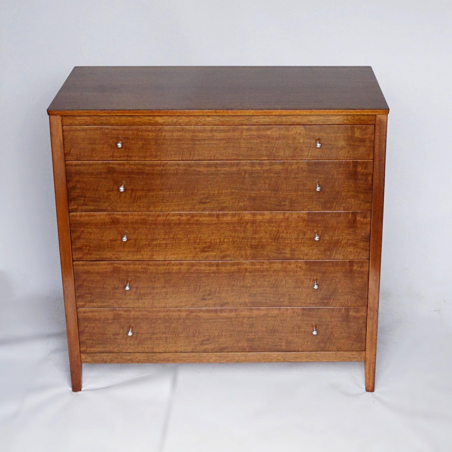 A midcentury chest of five drawers by Gordon Russell. Indian Laurel wood with solid teak frame. Original chromed metal handles. 

Dimensions: H 96cm, W 99cm, D 46cm 

Origin: English

Date: circa 1960

Item Number: 2502213

All of our