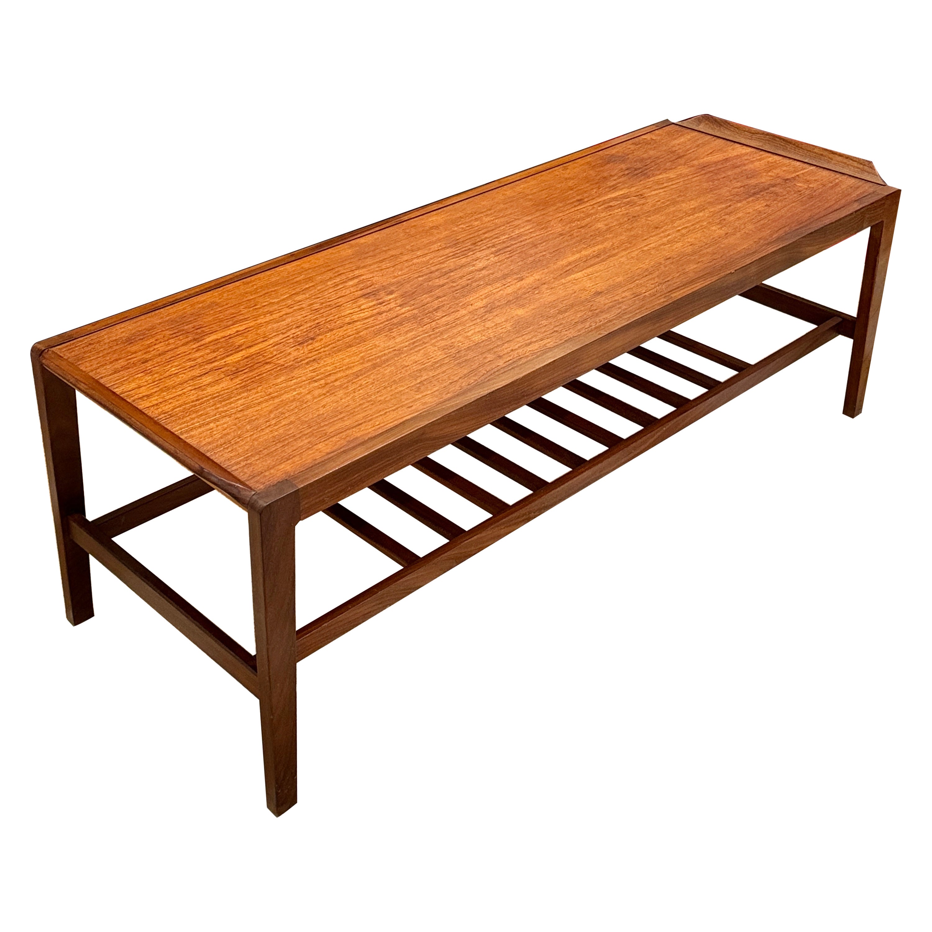 A mid century coffee table made from teak with a laddered magazine shelf 1960s