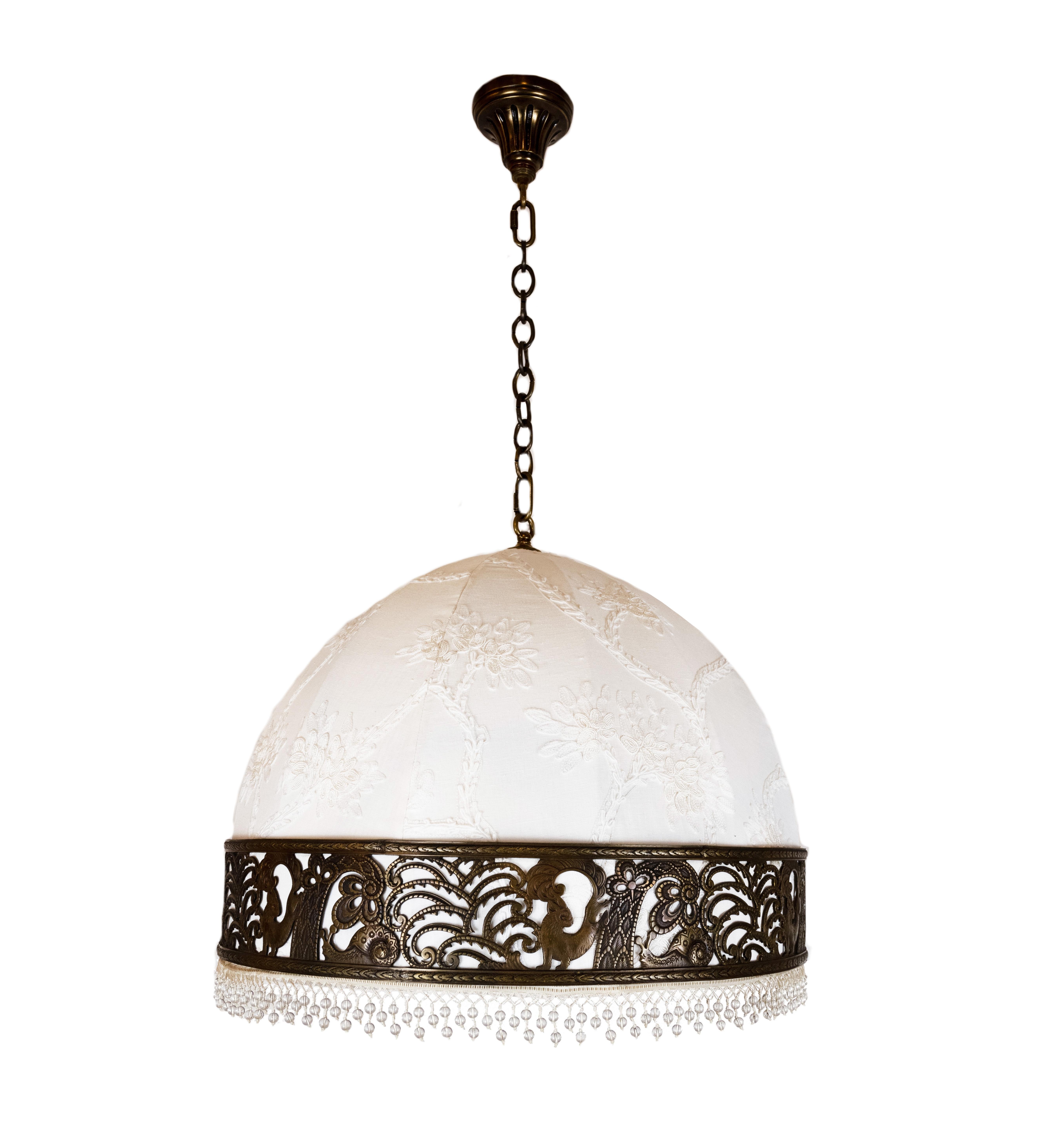 A mid-century pendant light with domed lampshade. The original shade frame recovered in Cowtan & Tout Farley in white, with fringe from Samuel & Sons. Featuring a cast brass band with scenes of stylized woodland flora and fauna. Circa 1940, includes