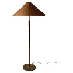 A Mid-Century Floor Lamp in Style of Paavo Tynell, Brass and Rattan, c. 1950s