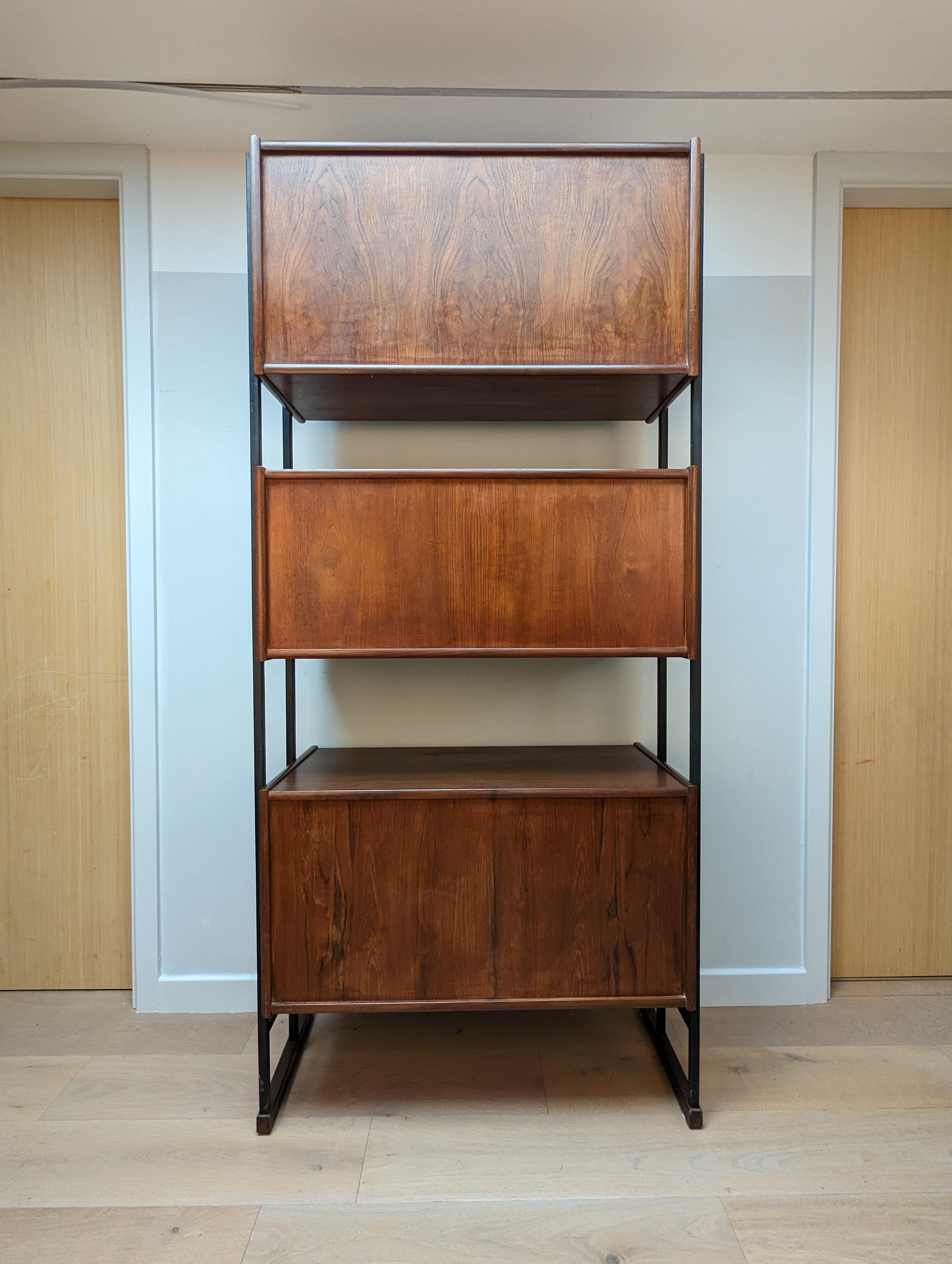 A very rare mid century shelving unit by Robex (makers mark on the inside brackets in the cupboards).

The unit consists of three drawers at the base and 2 display units with sliding glass doors. The top unit also has a shelf. 

The metal supports