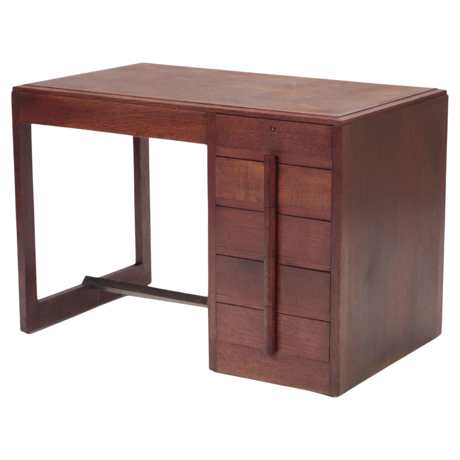 A Mid Century French oak desk in the manner of Charles Dudouyt, circa 1940.
