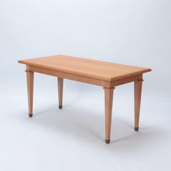 A Mid Century French oak library table, in the manner of Jacques Adnet, C. 1940.