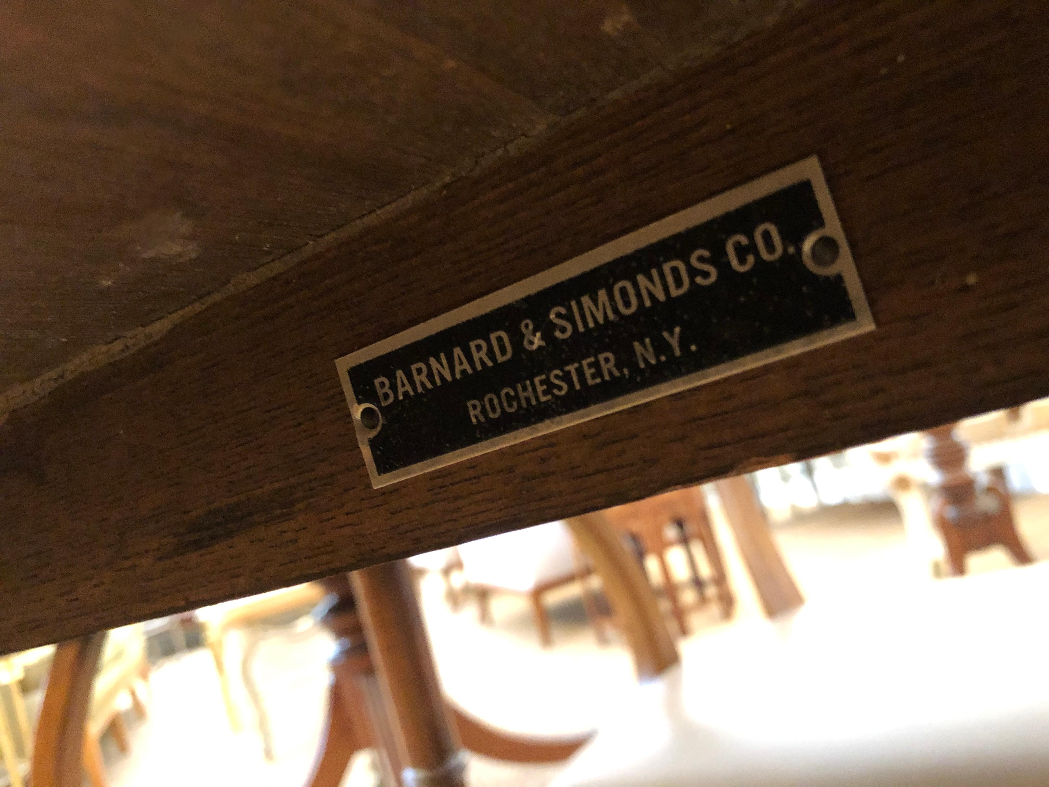 The square table with serpentine sides with four matching barrel-back chairs all with faux bamboo supports; new leather upholstery; Barnard & Simonds Co. (1898-1967) Rochester, NY moving to Grand Rapids, MI in 1959, purchased by Baker Furniture in