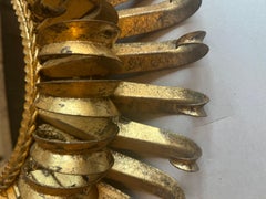 Midcentury Gilt Metal Eyelash Mirror Having a Beveled Mirror