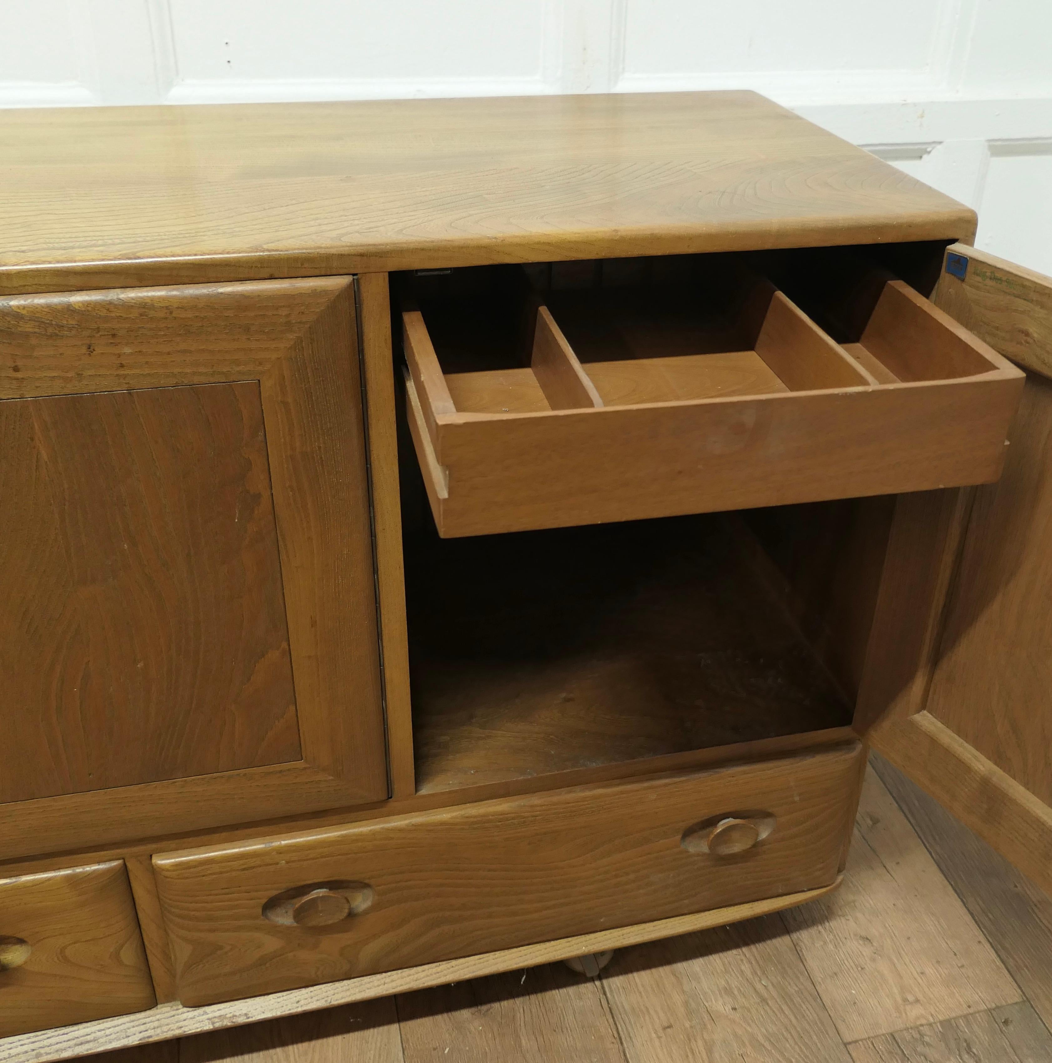 20th Century A Mid Century Golden Elm Sideboard by Ercol  The sideboard has 3 cupboard doors 