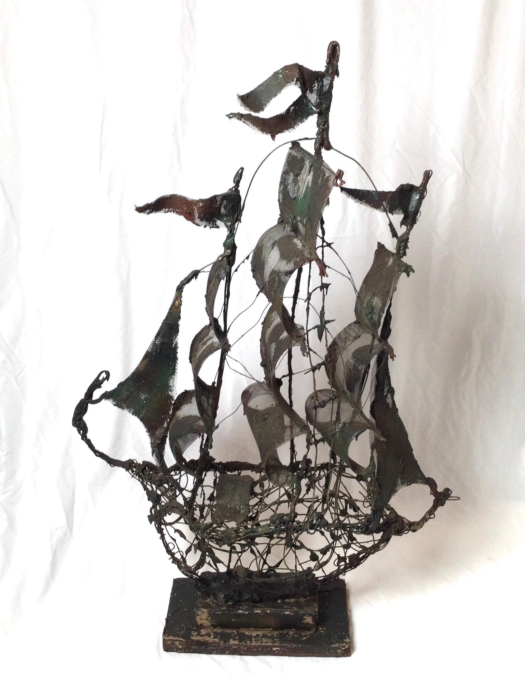 A freestanding 3 masted schooner with elaborate styling. metal, wood and wire. The aged and weather finish is intentional.