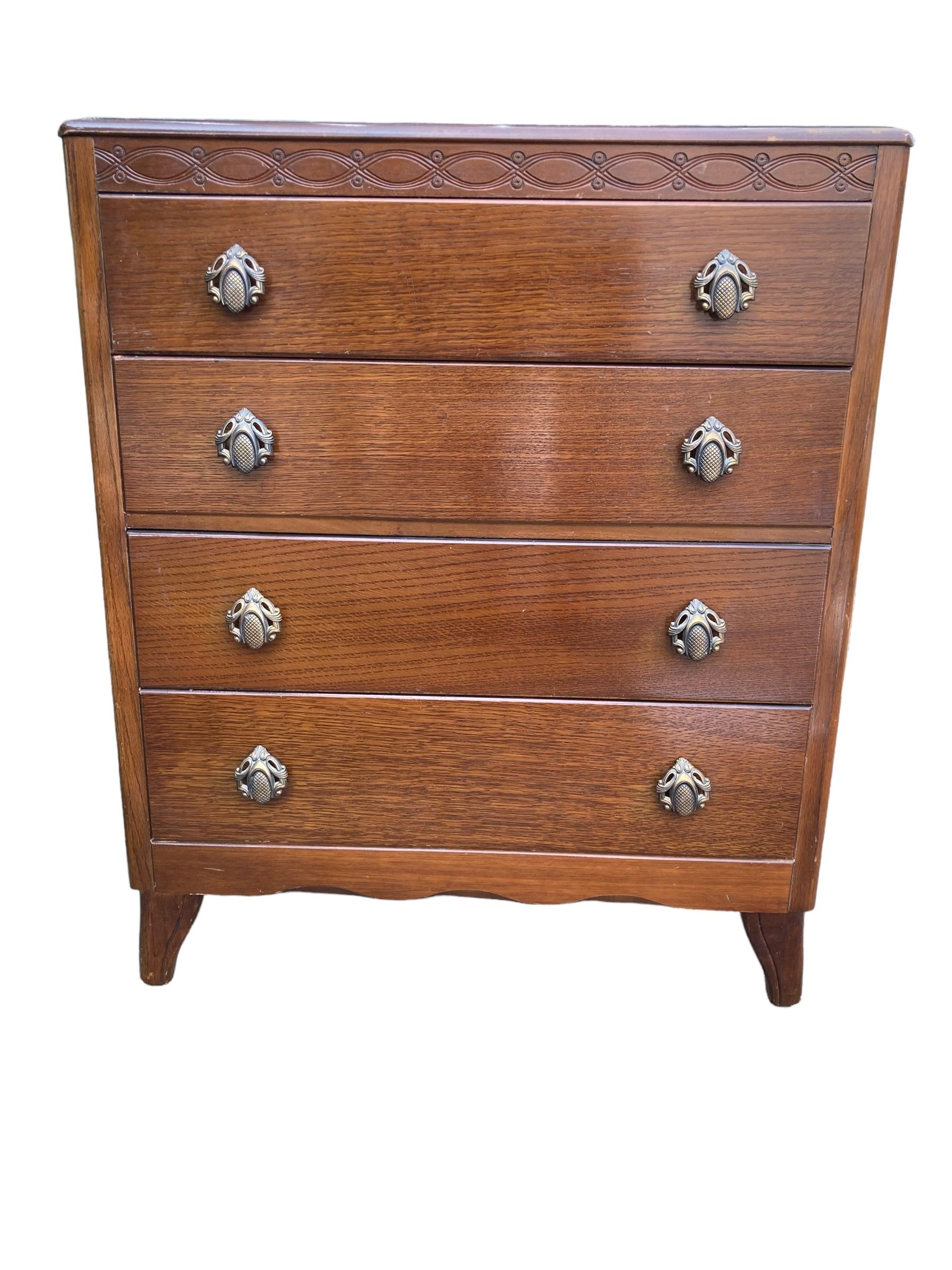 A Mid Century Harris Lebus Style Chest of Drawers Art Deco style handles. 
circa 1950s, it features featuring 4 drawers with dove-tail joints.
The oak veneer finish and the Art Deco style handles gives a classical look with patina that adds more