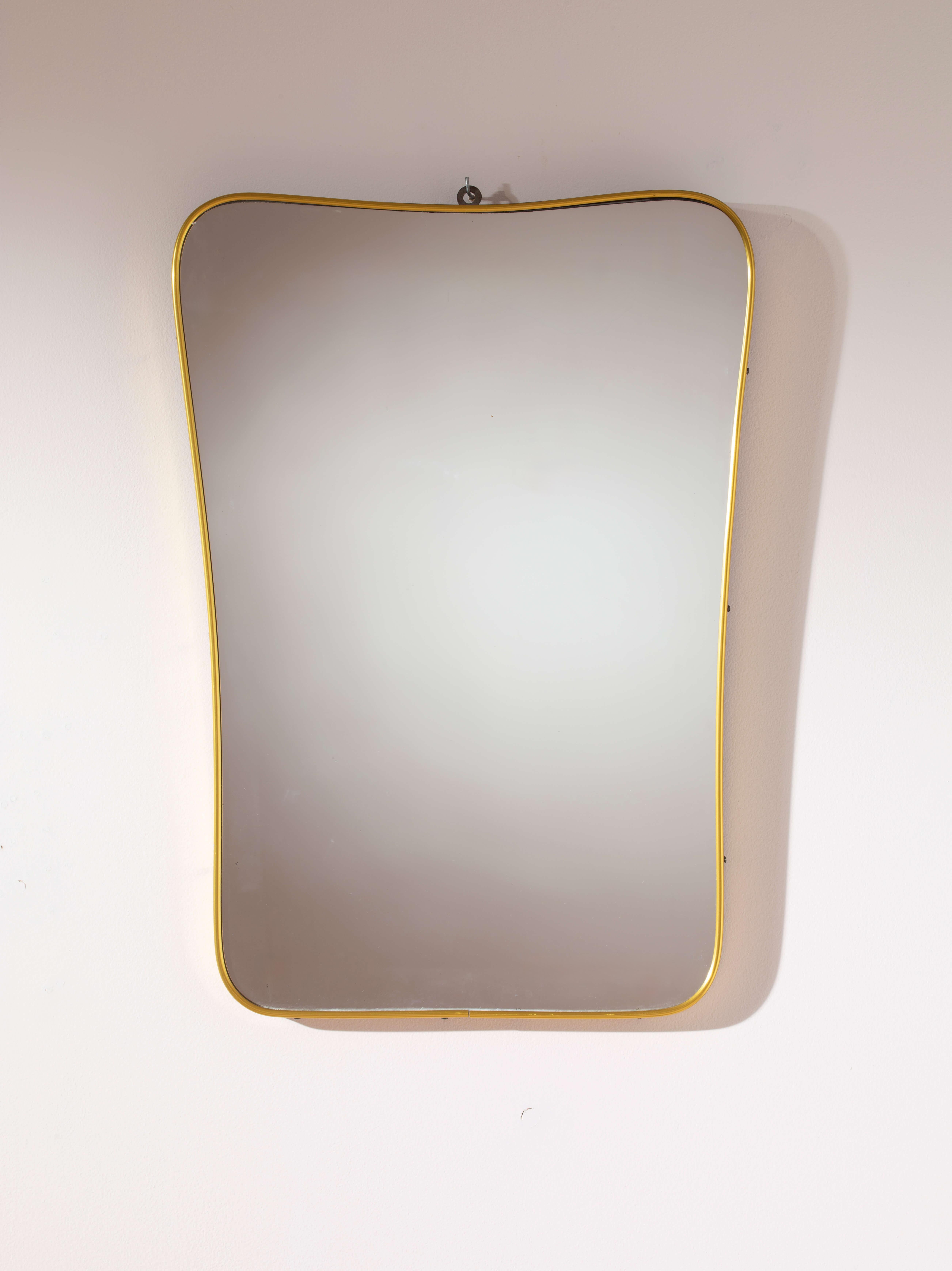 The mirror - a captivating object, a symbol of vanity, and a decorative element that brings character to any space.

We present an exquisite Italian mirror from the 1960s, distinguished by its refined and uniquely elegant silhouette. The design