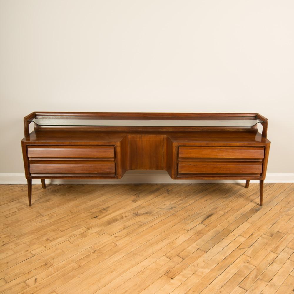 A midcentury Italian rosewood dresser with glass shelf and four drawers circa 1950. Perfect for under your flat screen television.