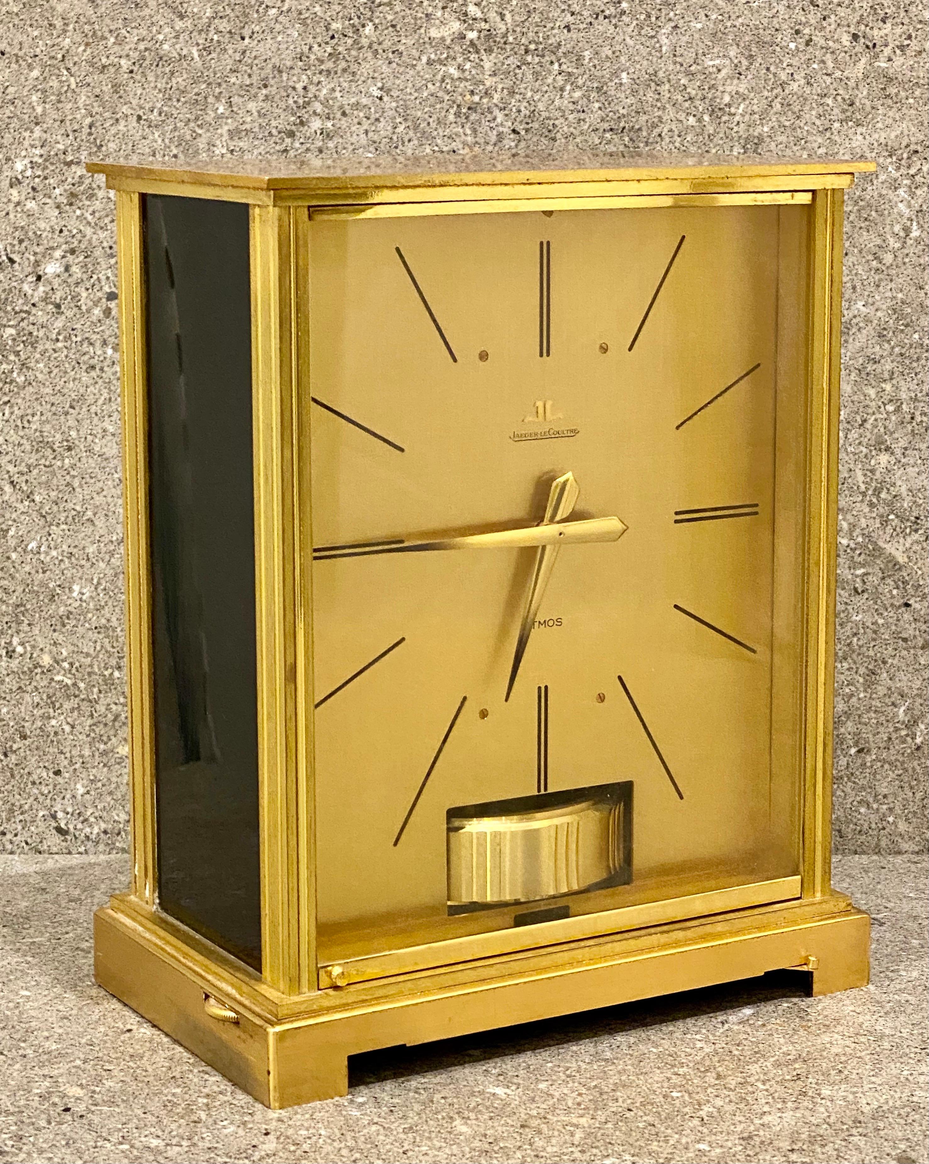 A nice example of A Jaeger Le Coultre Atmos clock, Embassy, signed Jaeger Le Coultre, , base with stop lever, dial with Roman chapter ring and visible balance wheel below, 22cm high, with Jaeger Le Coultre booklet and original box.
   