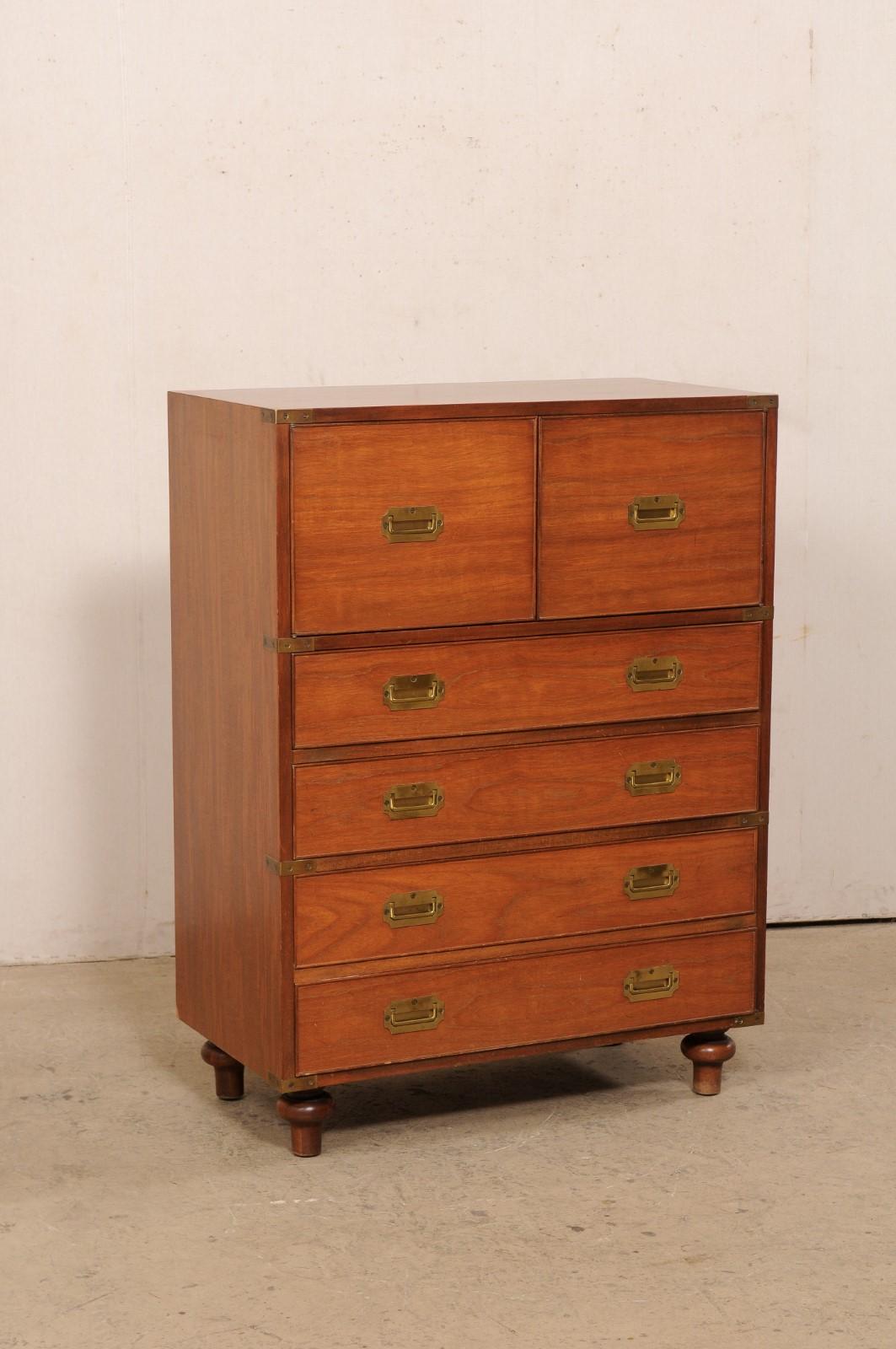 A mahogany wood campaign chest by New England furniture maker Beacon Hill Collection (labeled as piece #311) from the mid 20th century. This mahogany storage piece stands approximately four feet tall and features a cleanly designed case fitted with