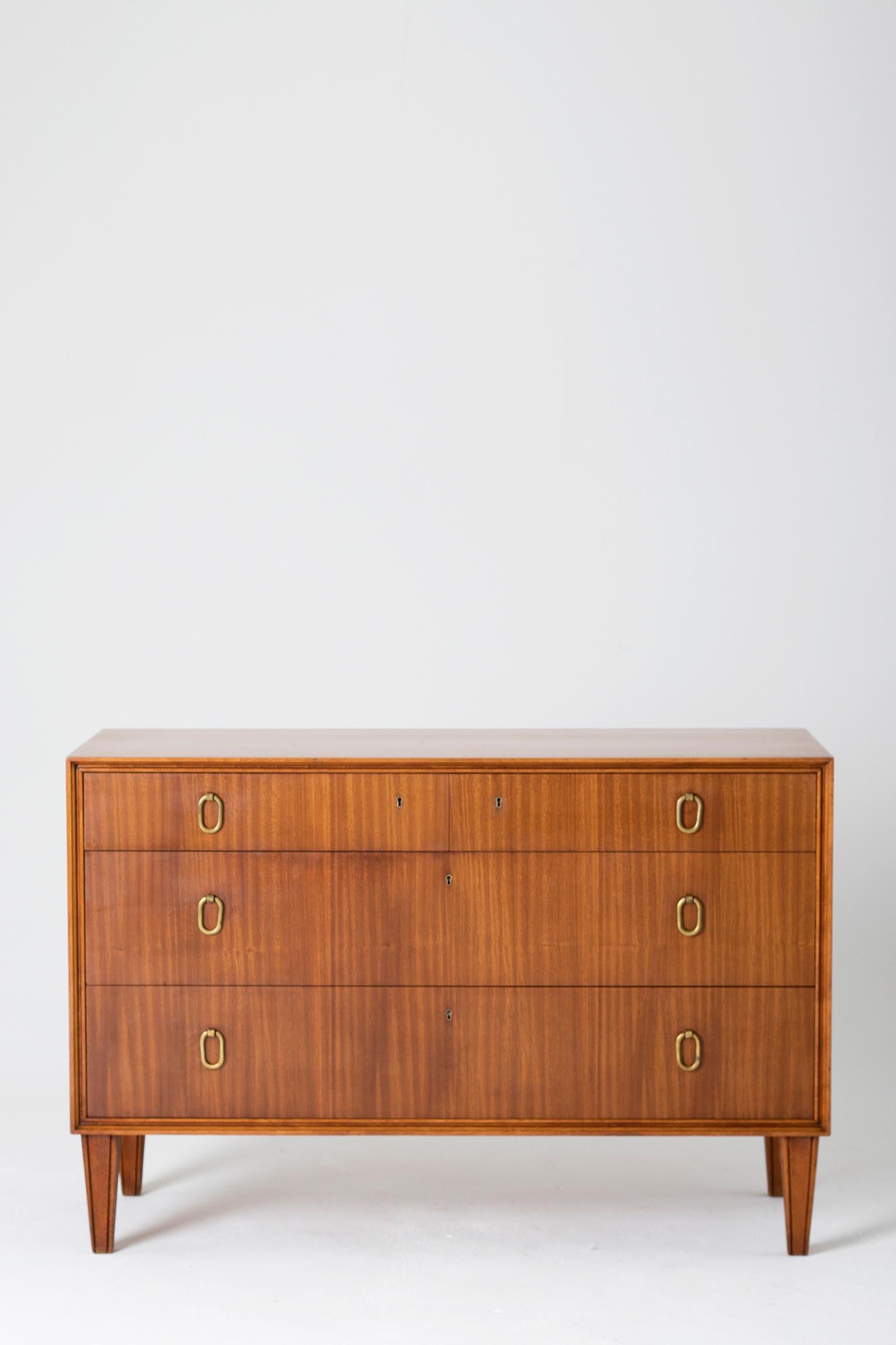 A mahogany and brass chest of drawers by Axel Larsson (1898-1975) for Bodafors,
Sweden, late 1950s.
