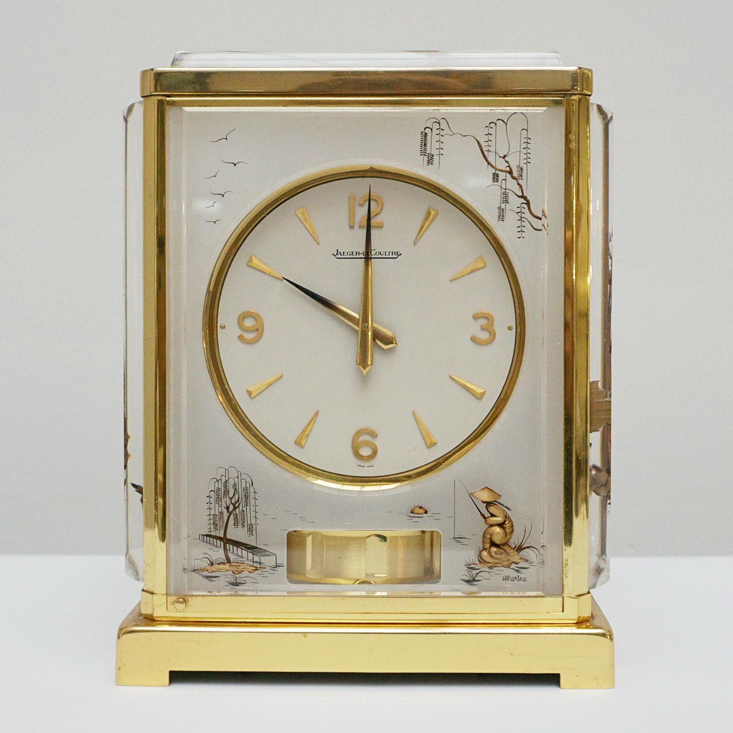 A midcentury marina atmos clock by Jaeger-LeCoultre. Lucite and brass case with inset brass chinoiserie decoration. Eight day movement by Jaeger-LeCoultre with baton numerals and original gilded hands. Marina inset to lower right corner.

Origin: