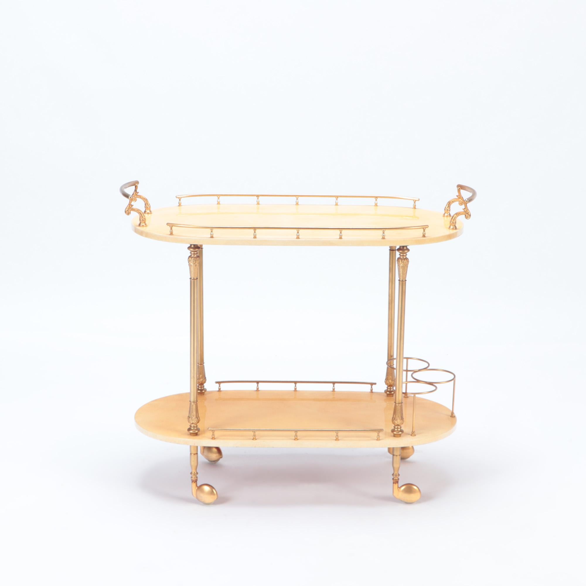 A Mid-Century Modern bar cart/trolley by Aldo Tura. Two lacquered goatskin tiered shelves with brass mounts on four caster feet. Circa 1960.