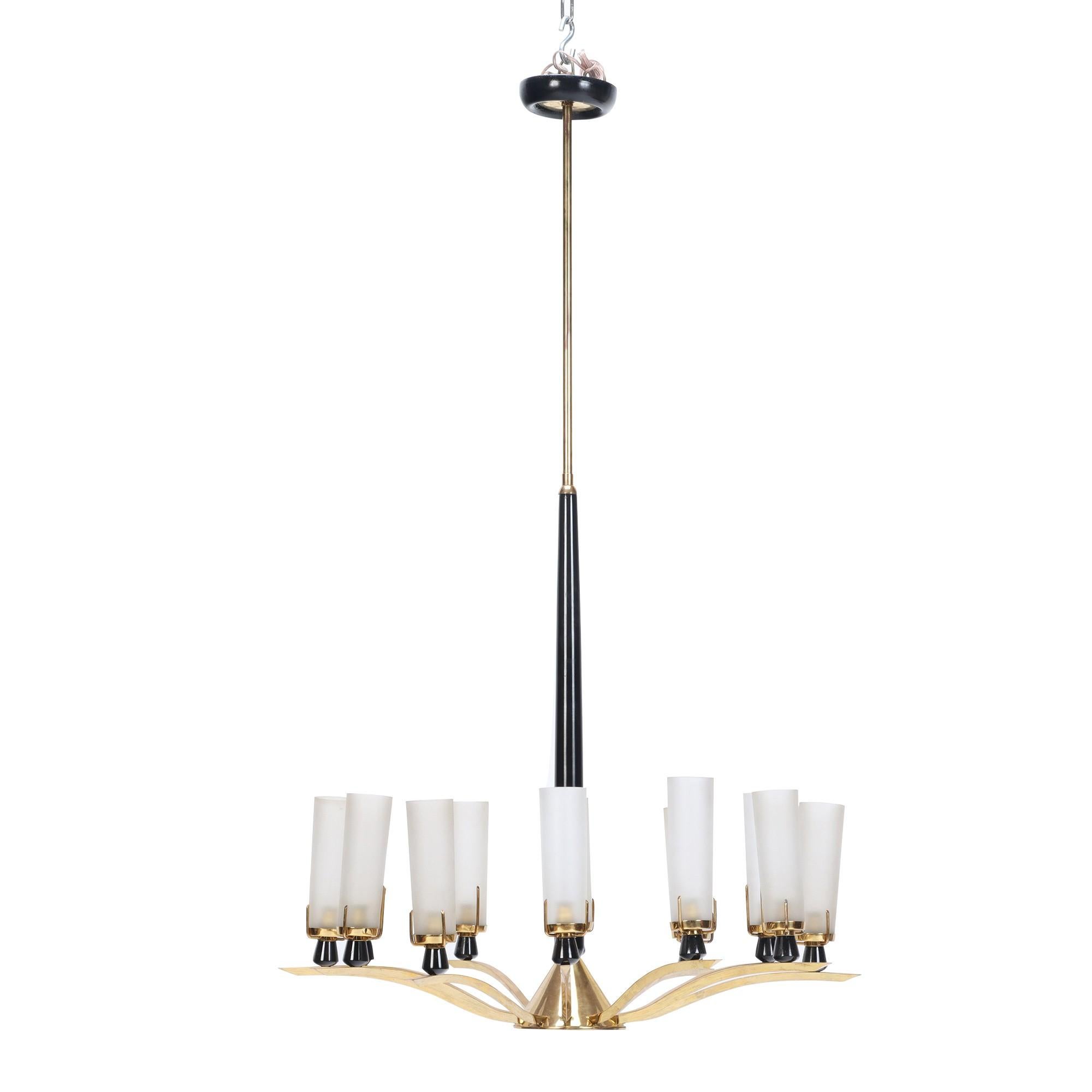 A Mid-Century Modern circular black and brass 12 candlestick chandelier in the style of Tommi Parzinger, circa 1950.