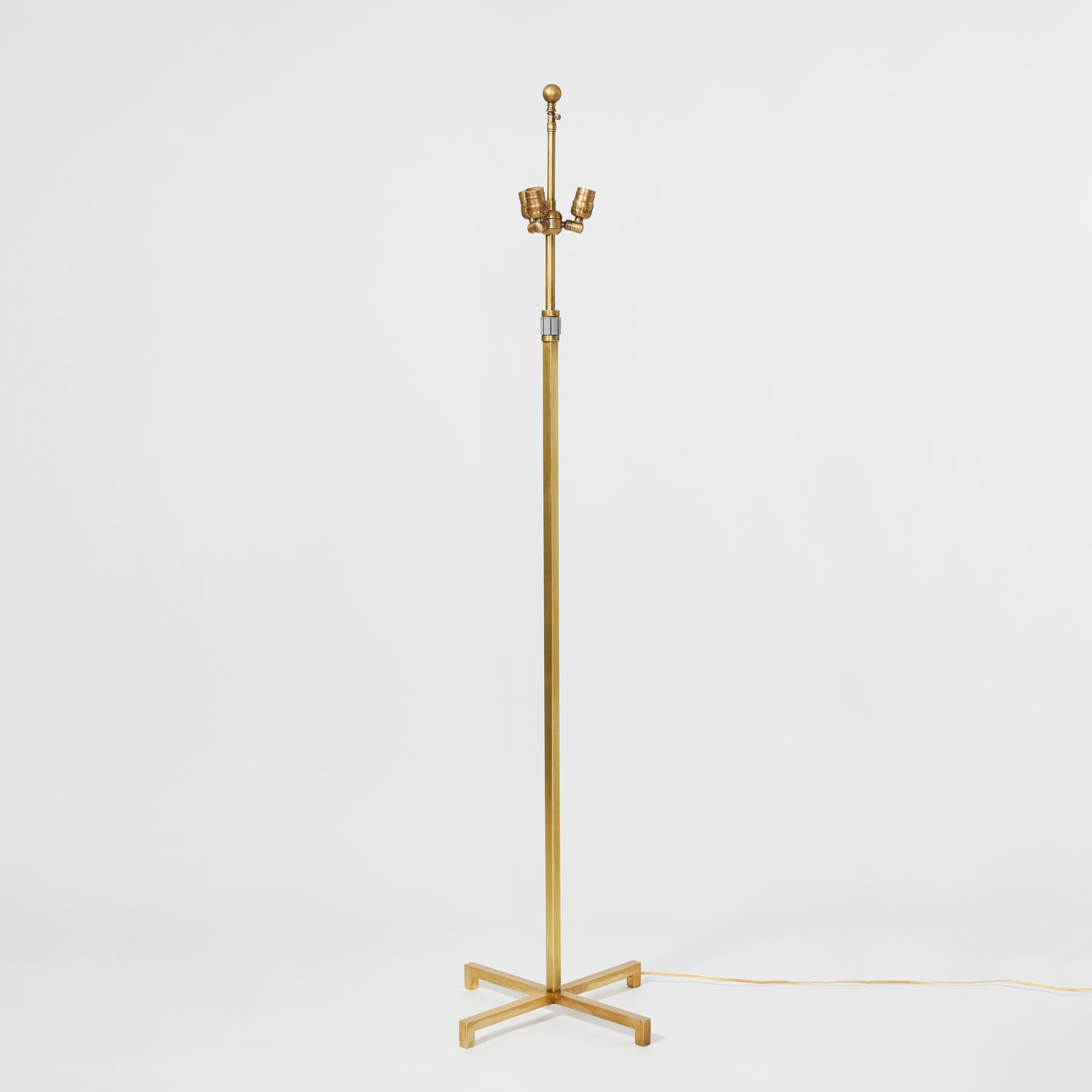 A Mid-Century Modern brass standing lamp with brass square rod construction, three medium base sockets, and unique barrel switch below lamp cluster.

Measures: 17'' W x 17'' D x 62''- 66'' H(Adjustable).