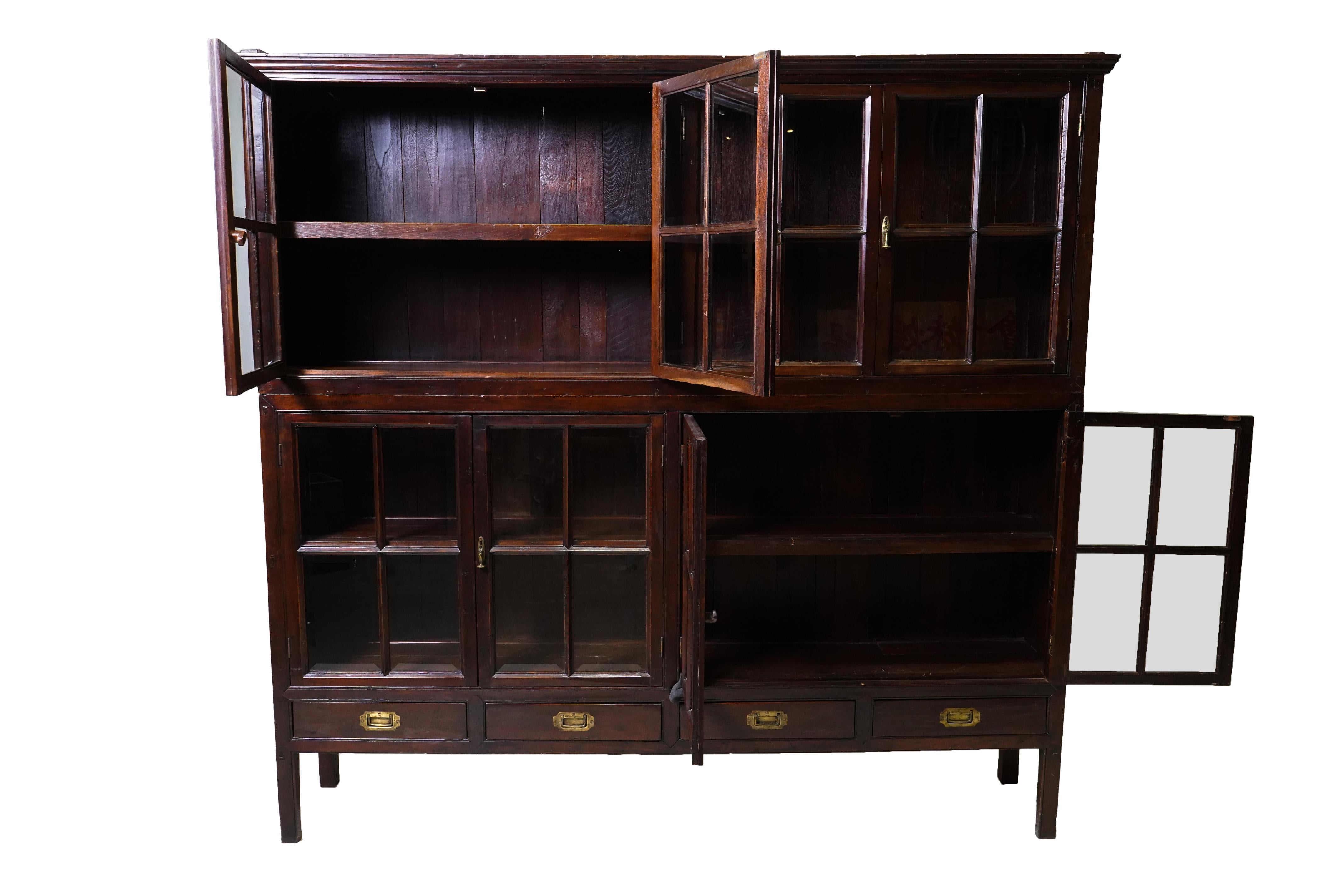 This solid teak bookcase was made around 1900 AD in Rangoon, Burma in the classic British style.  We call these impressive pieces by different names; 