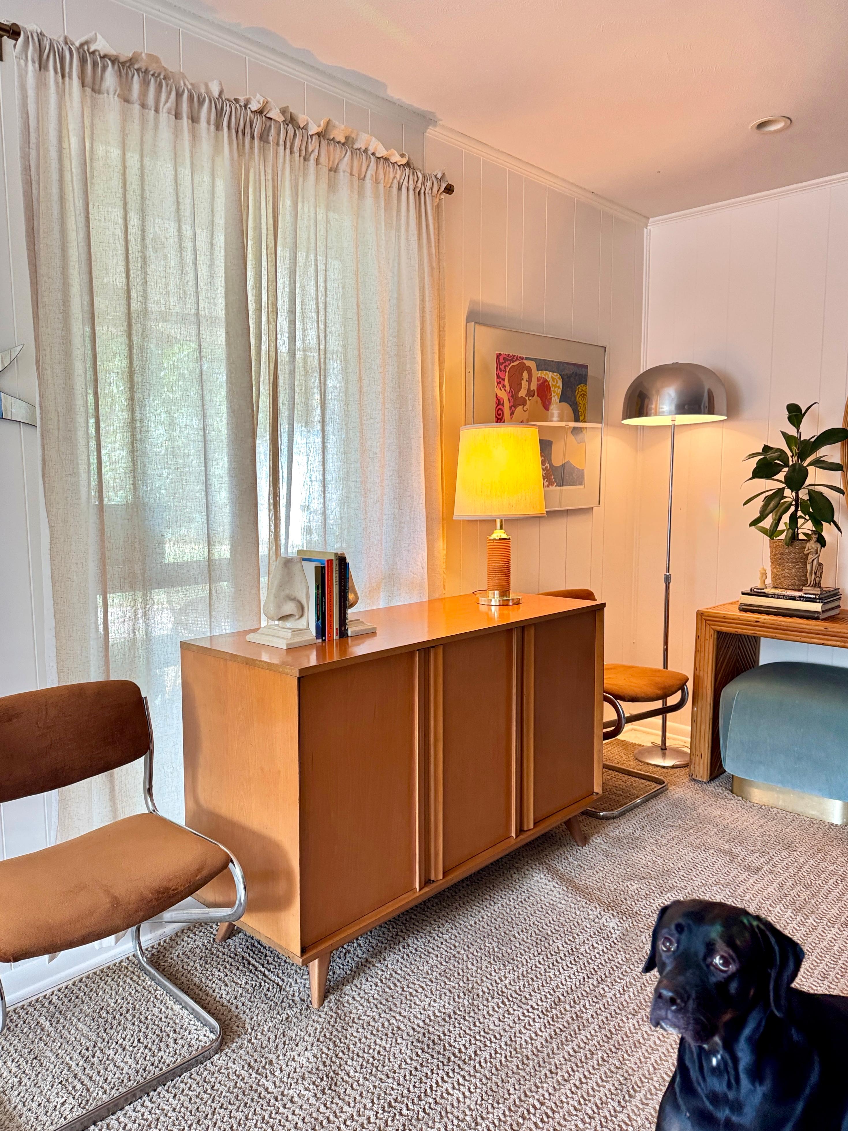 A mid century modern buffet by Viko Baumritter of New York (the original company behind Ethan Allen), circa 1960s. This buffet or sideboard has four drop in drawers concealed behind the left door and a two door cabinet at right. Crafted from maple