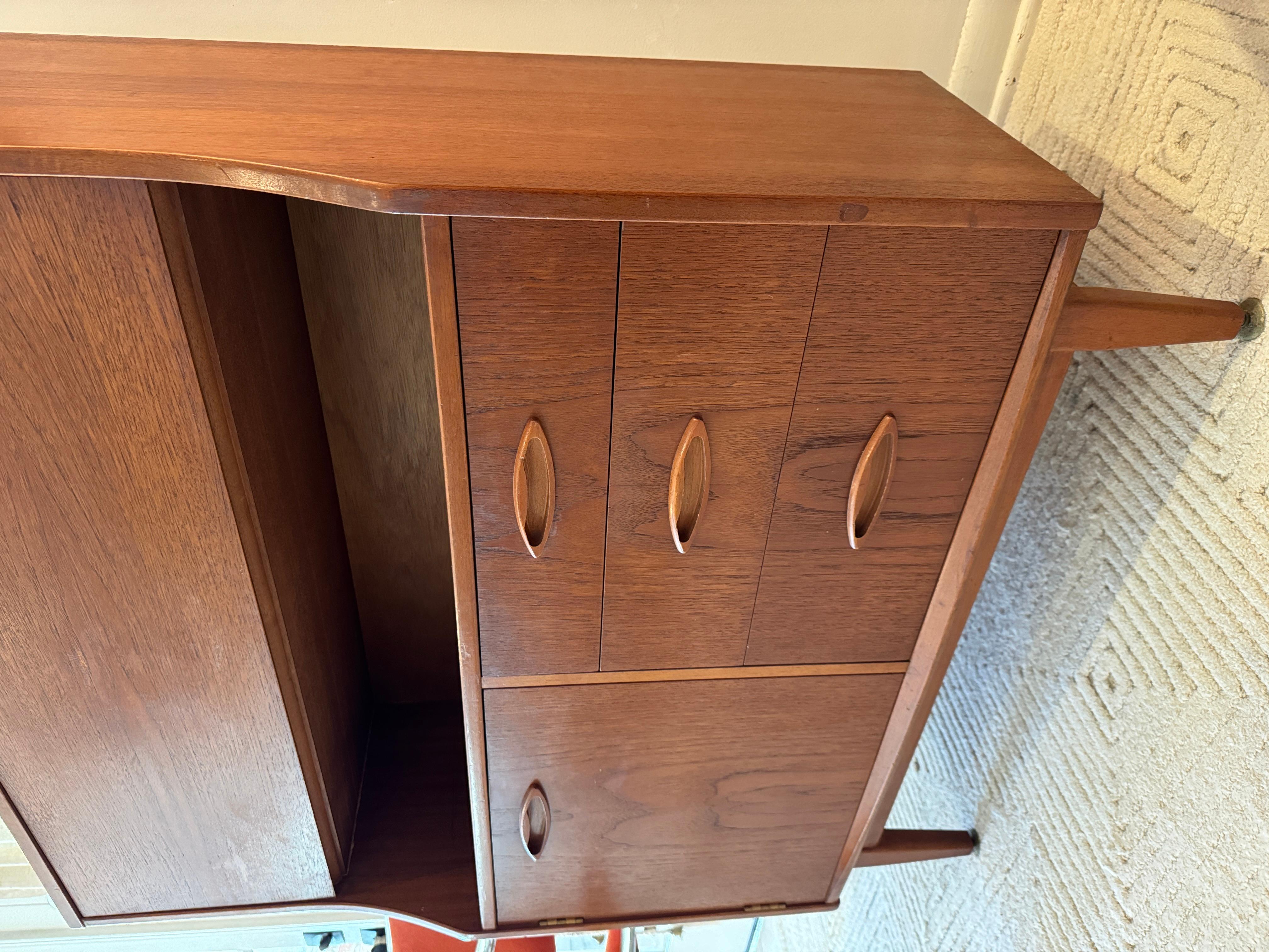 A mid century modern cabinet with a drop front desk by Jentique furniture 4