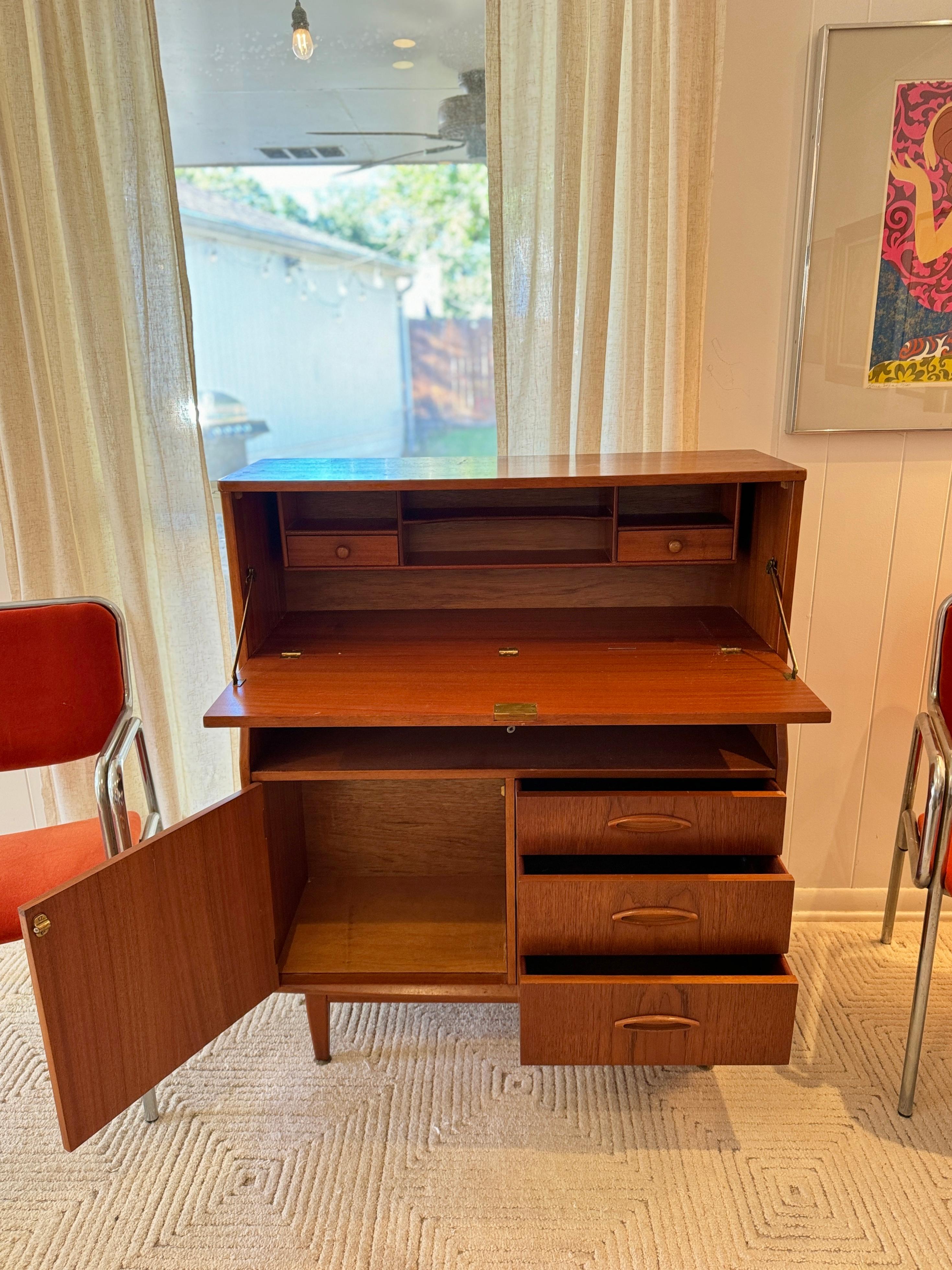 Teak A mid century modern cabinet with a drop front desk by Jentique furniture