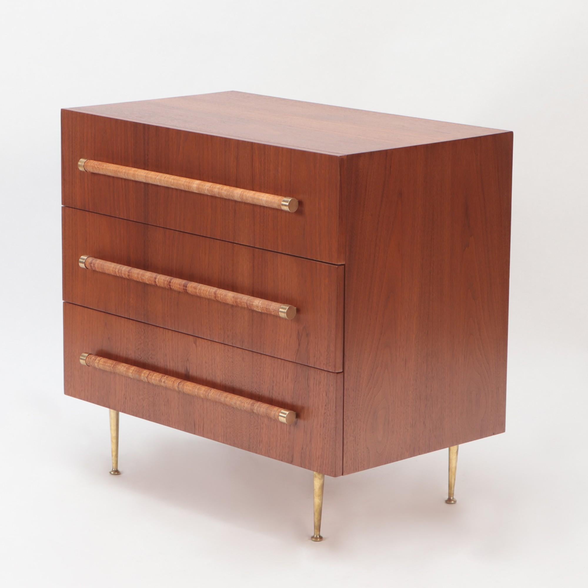 A Mid-Century Modern chest. Designed by T.H. Robsjohn-Gibbings for Widdicomb. Walnut with cane wrapped handles and brass legs.